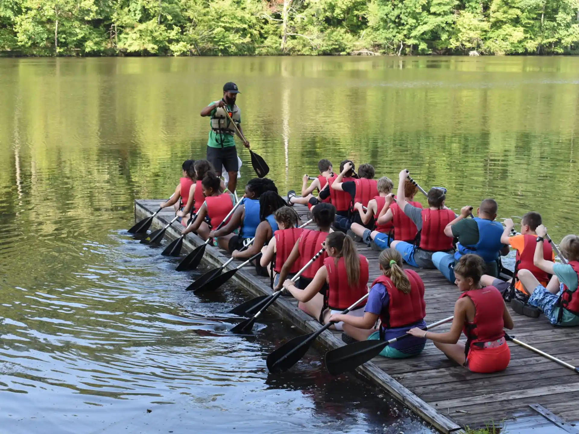 a group of people rowing a boat