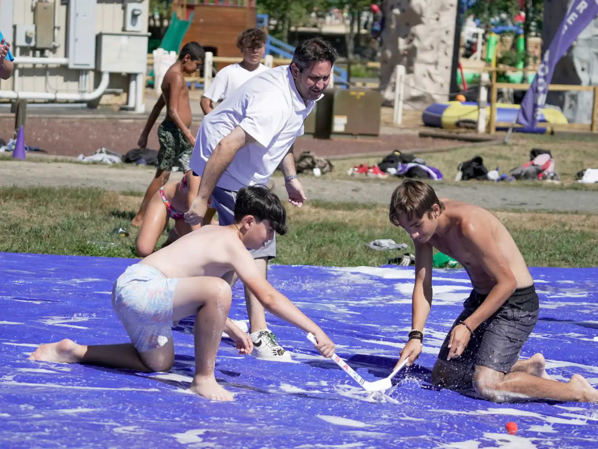 a group of people playing with a rope on a beach