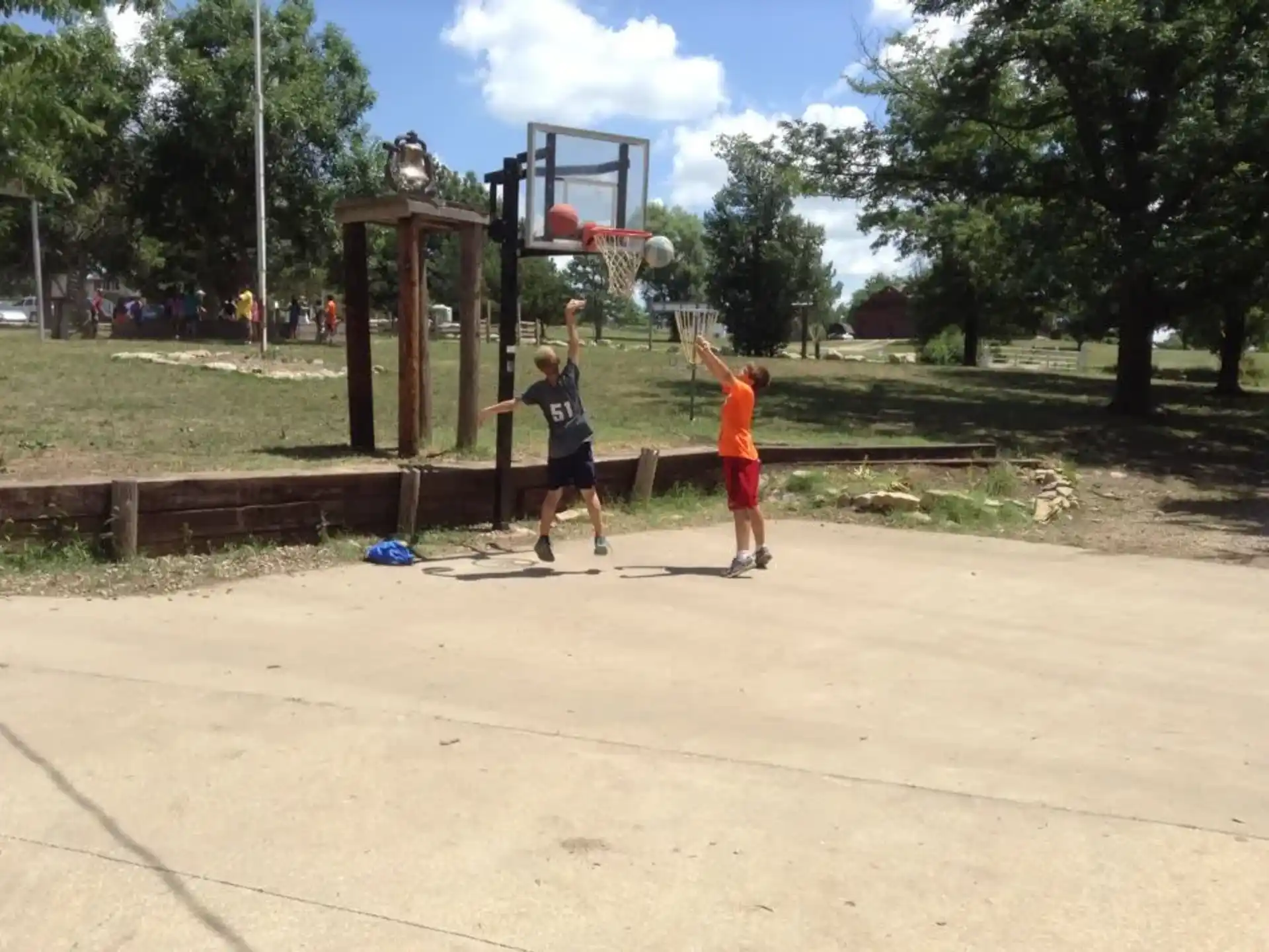 a couple of boys playing basketball