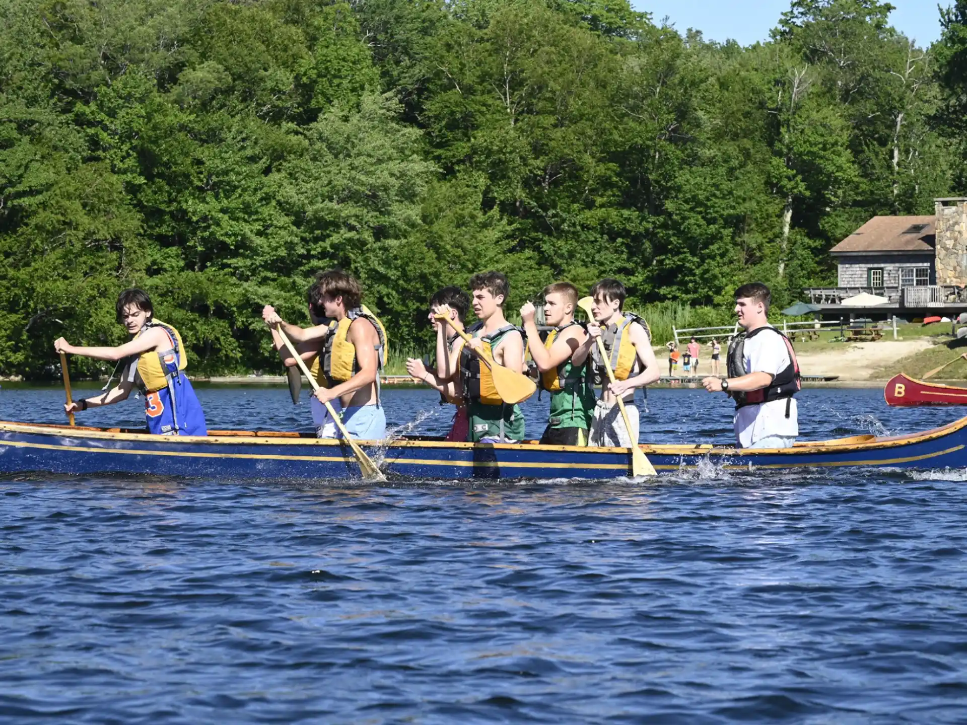 a group of people rowing a boat
