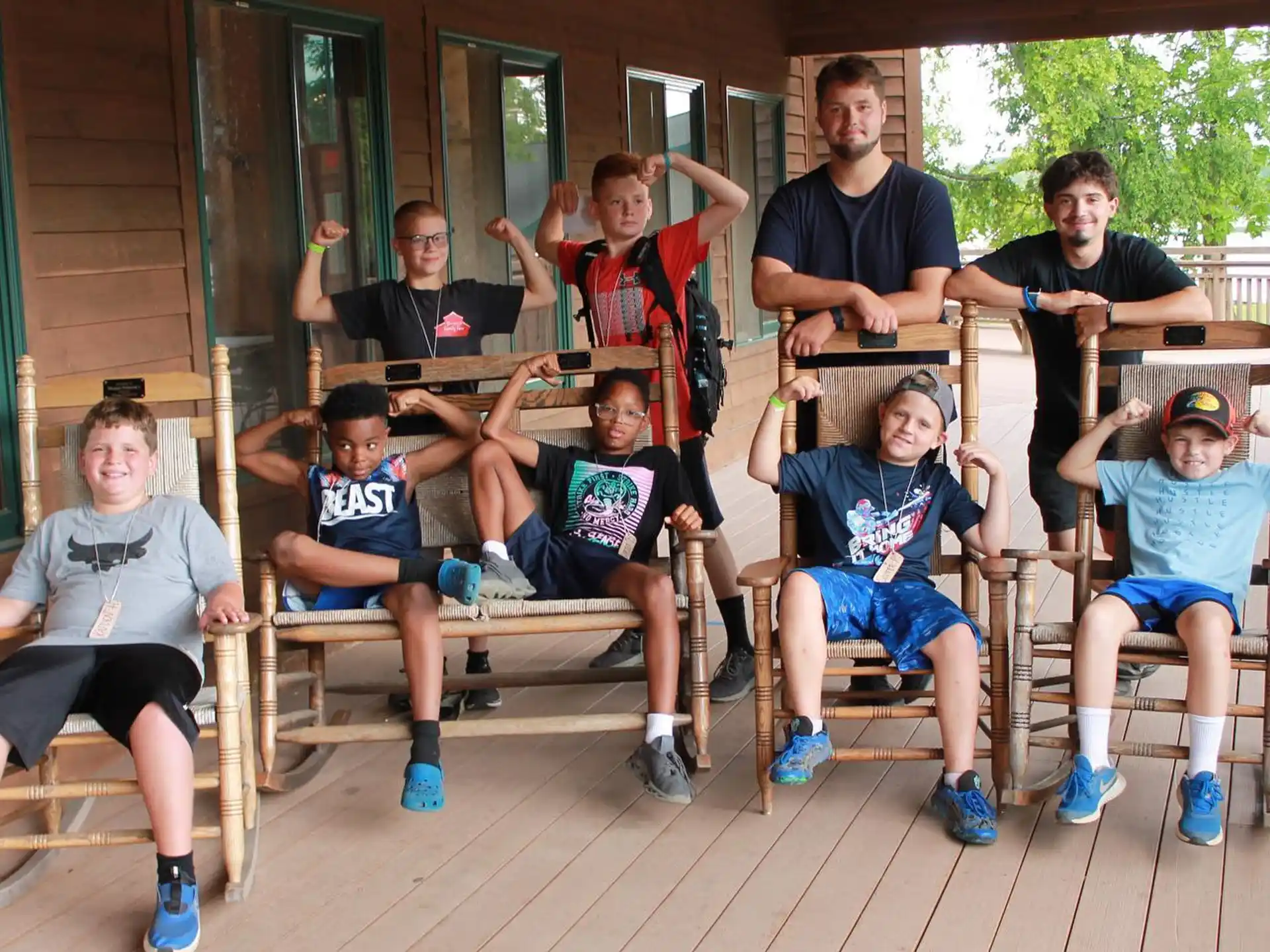 a group of people sitting on a bench posing for the camera