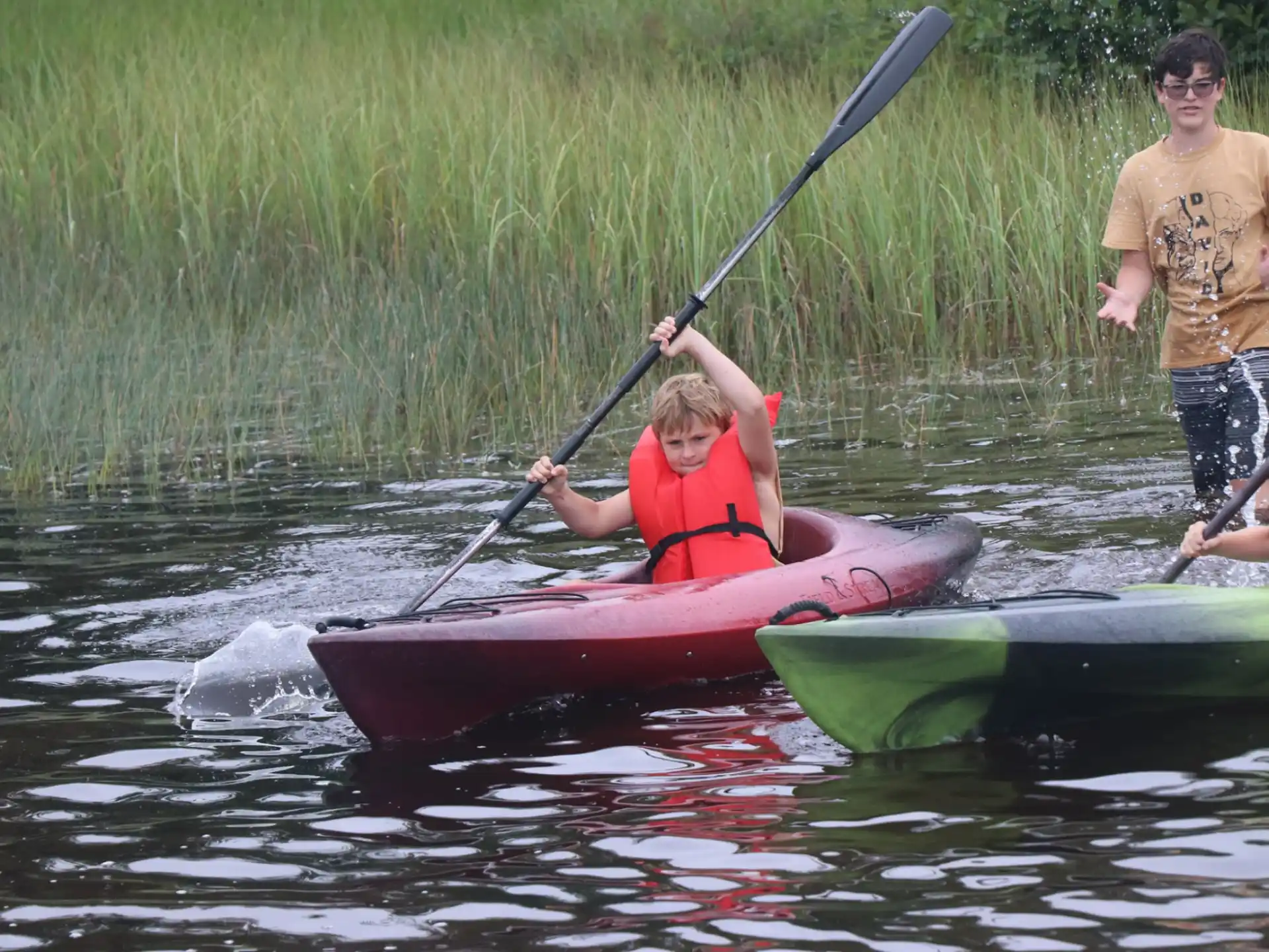 a man and a boy in a canoe on a river