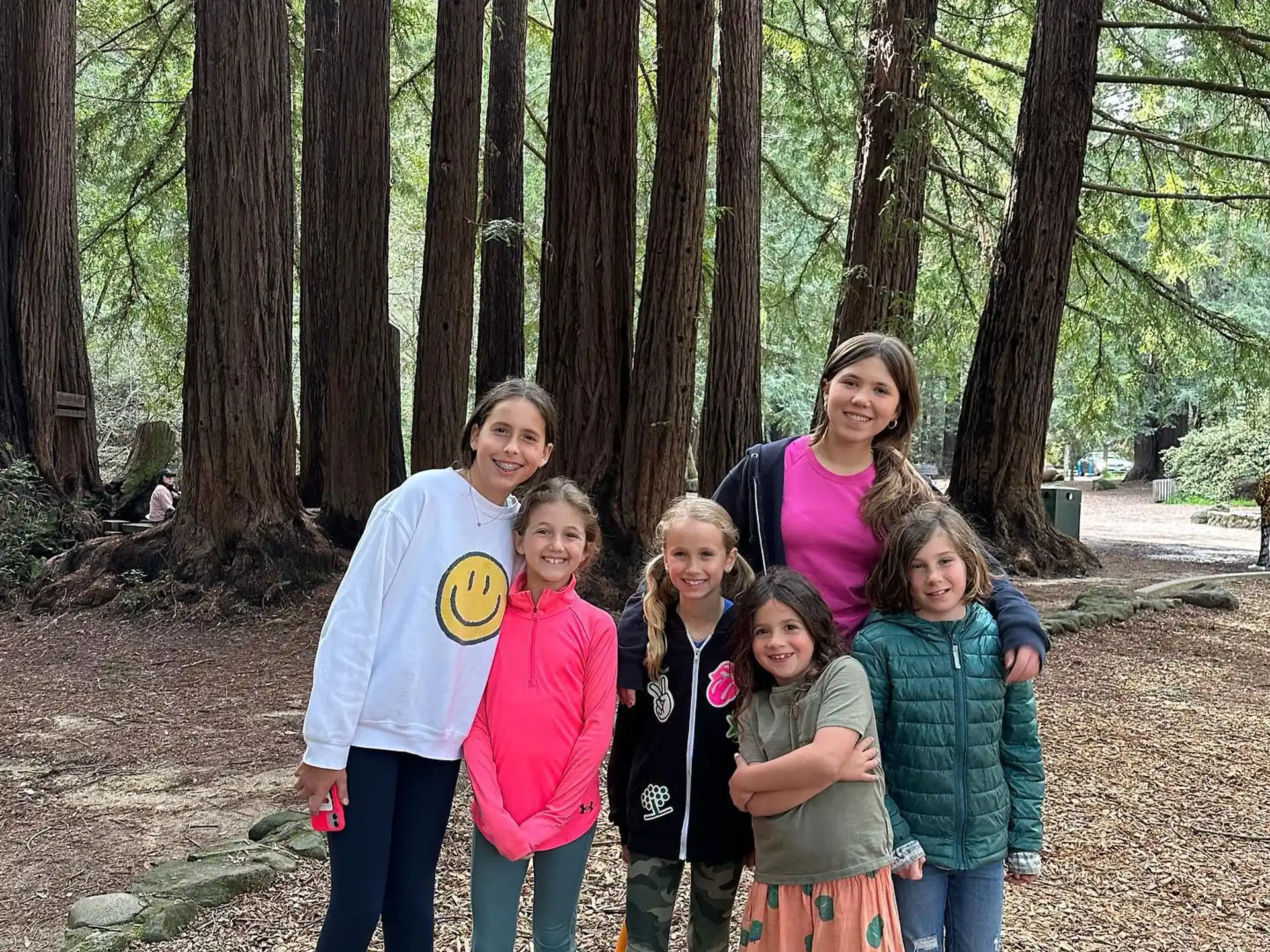 a group of people posing for a photo in the woods