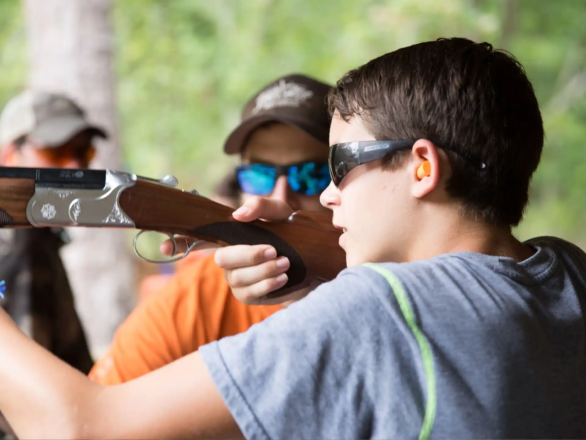 a man wearing sunglasses and holding a gun