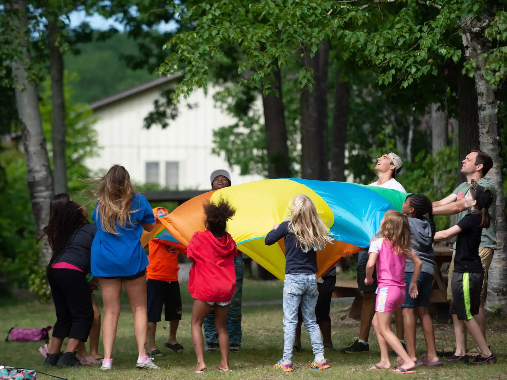 a group of people holding a yellow and blue tent