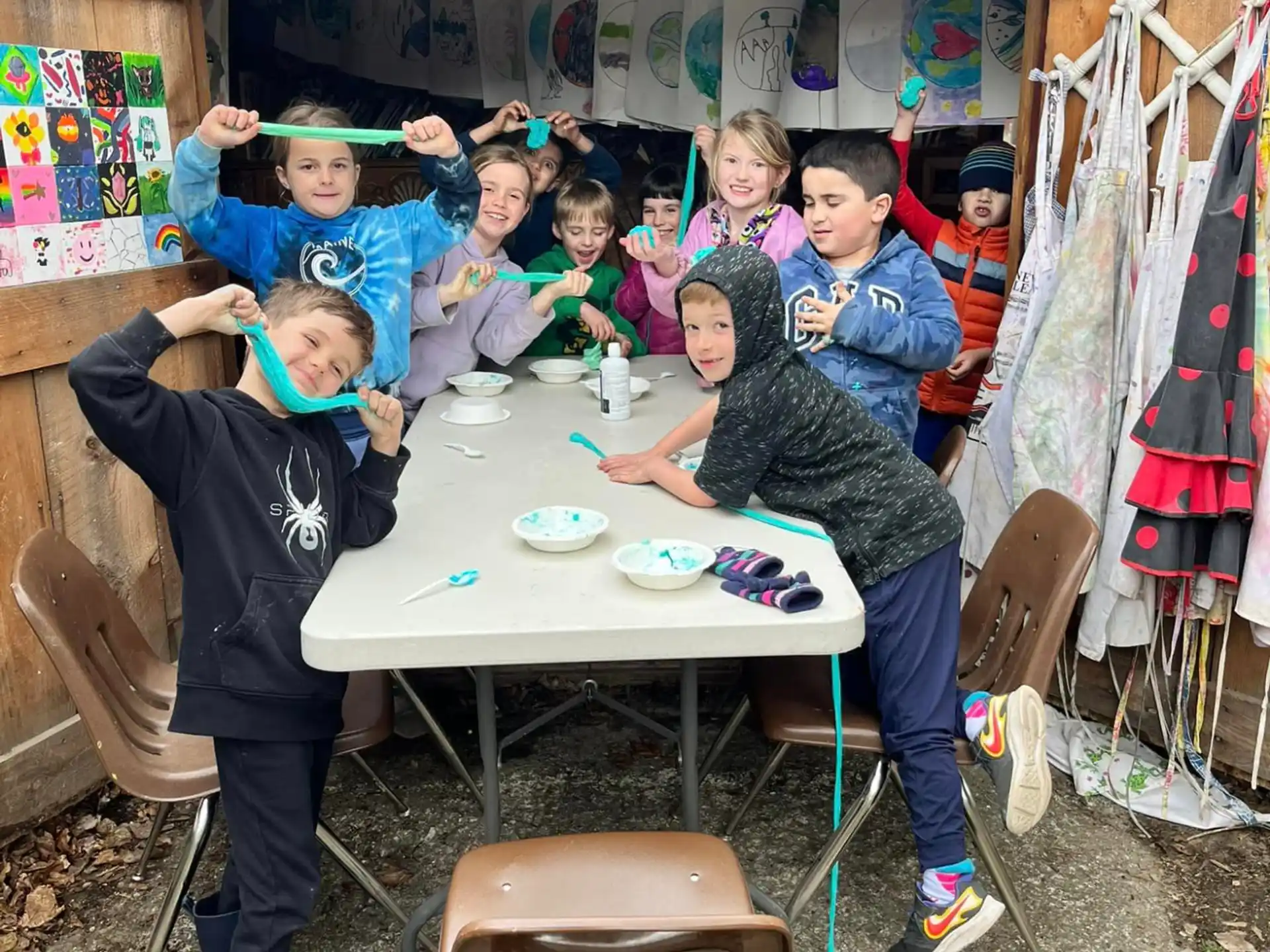 a group of children sitting around a table