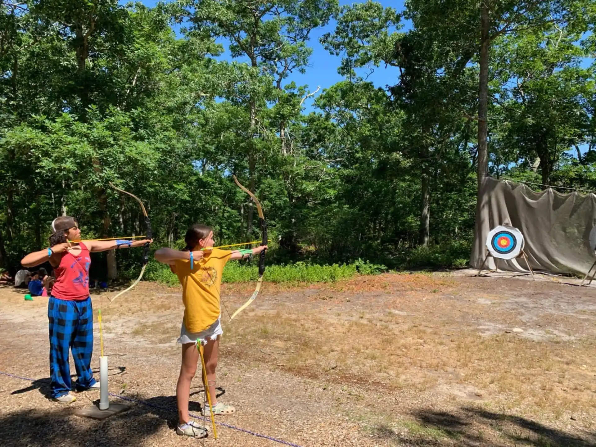 a couple of boys shooting bows