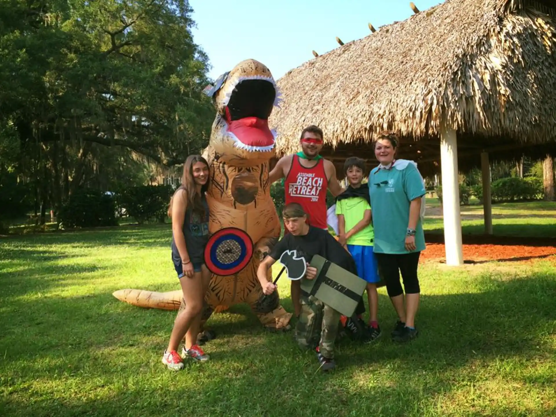 a group of people posing with a person in a garment