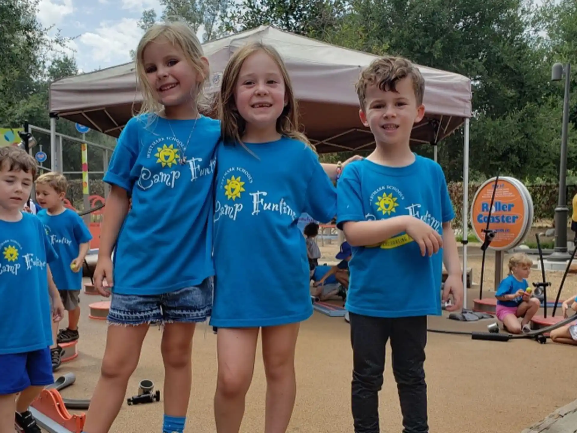 a group of children in blue shirts