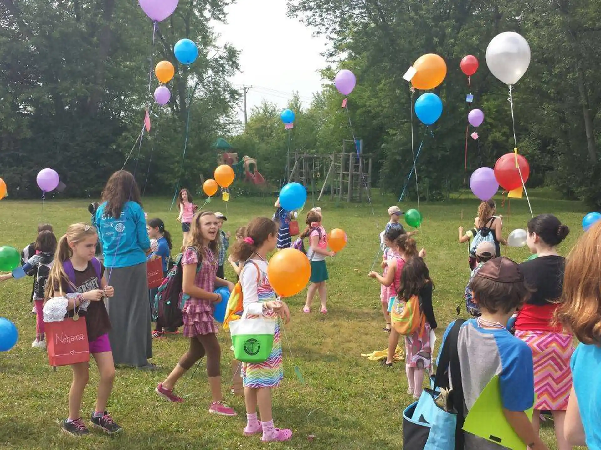 a group of children holding balloons