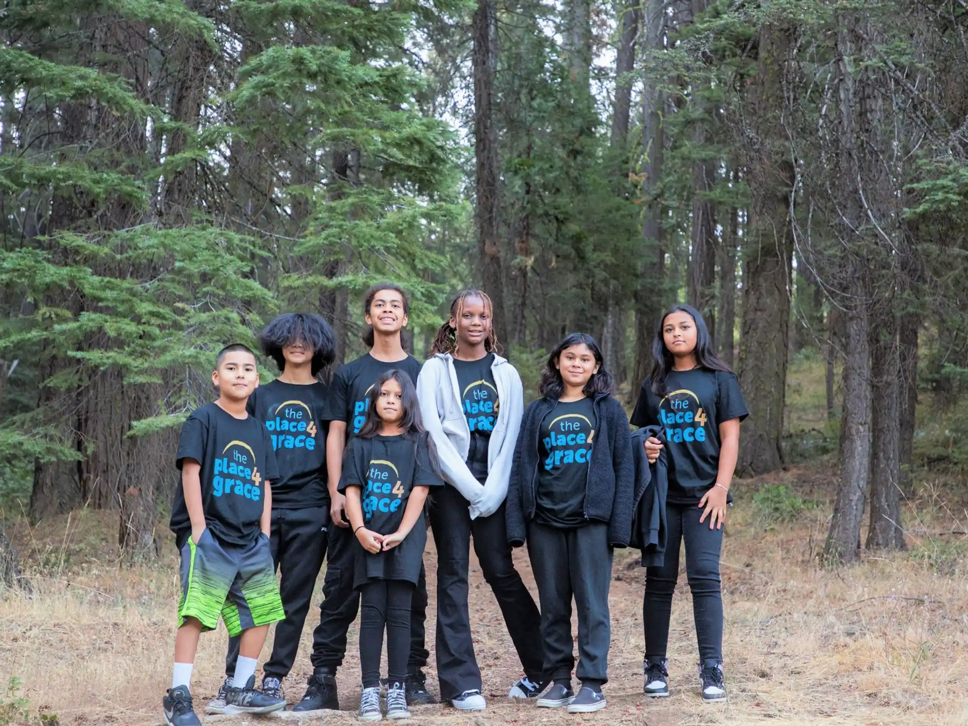 a group of people posing for a photo in the woods
