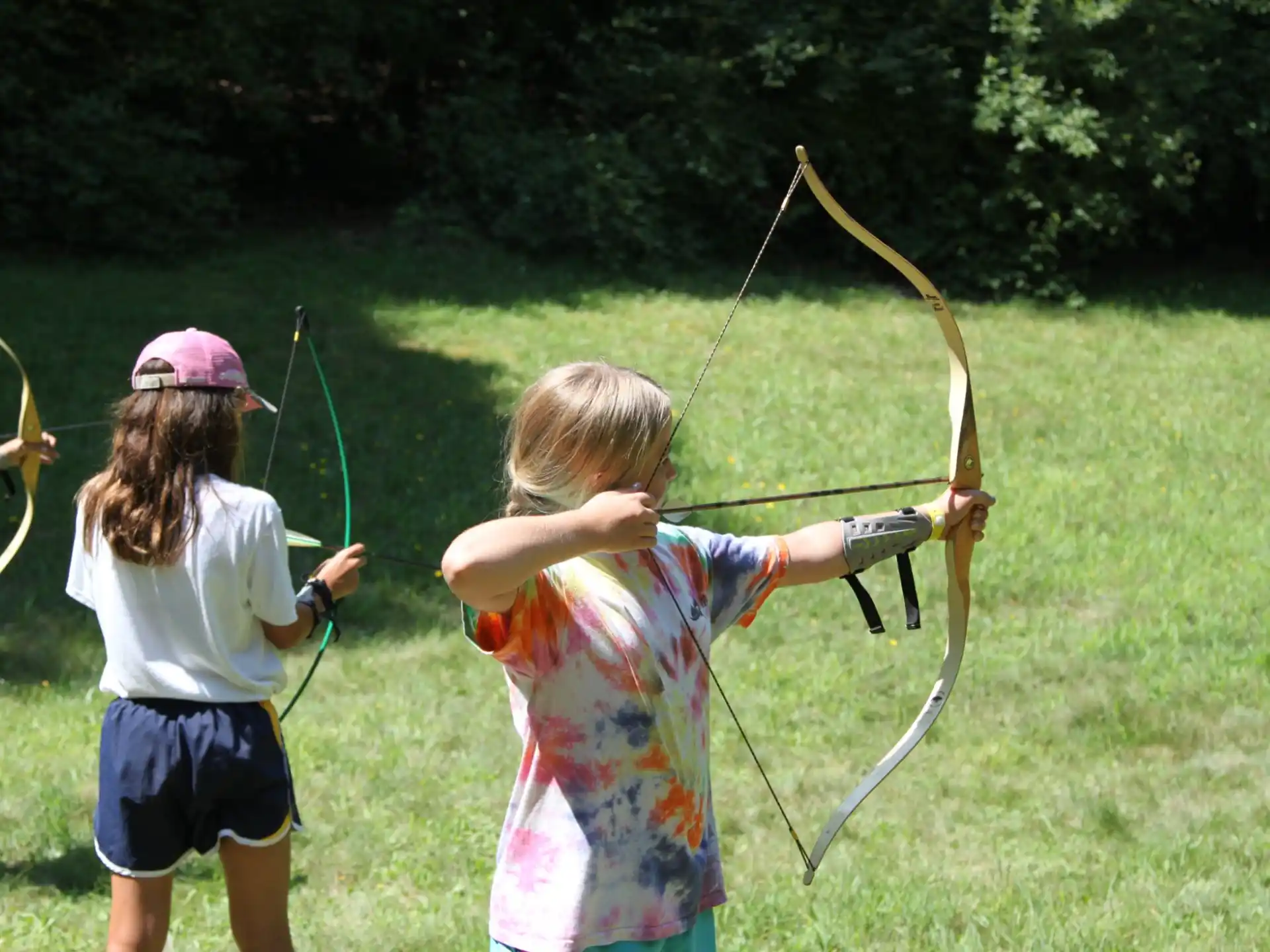 a couple of kids shooting bows