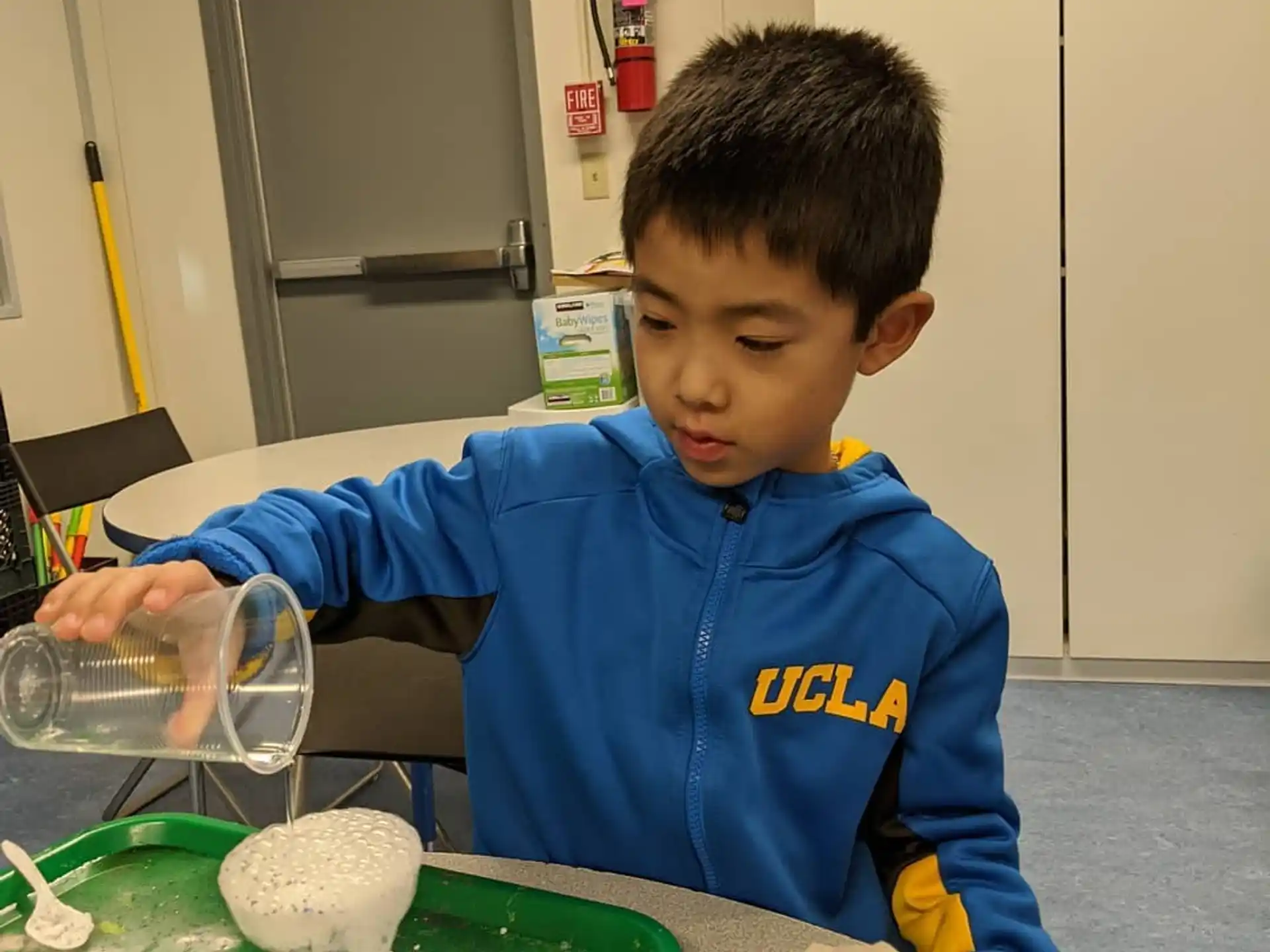 a boy sitting at a table