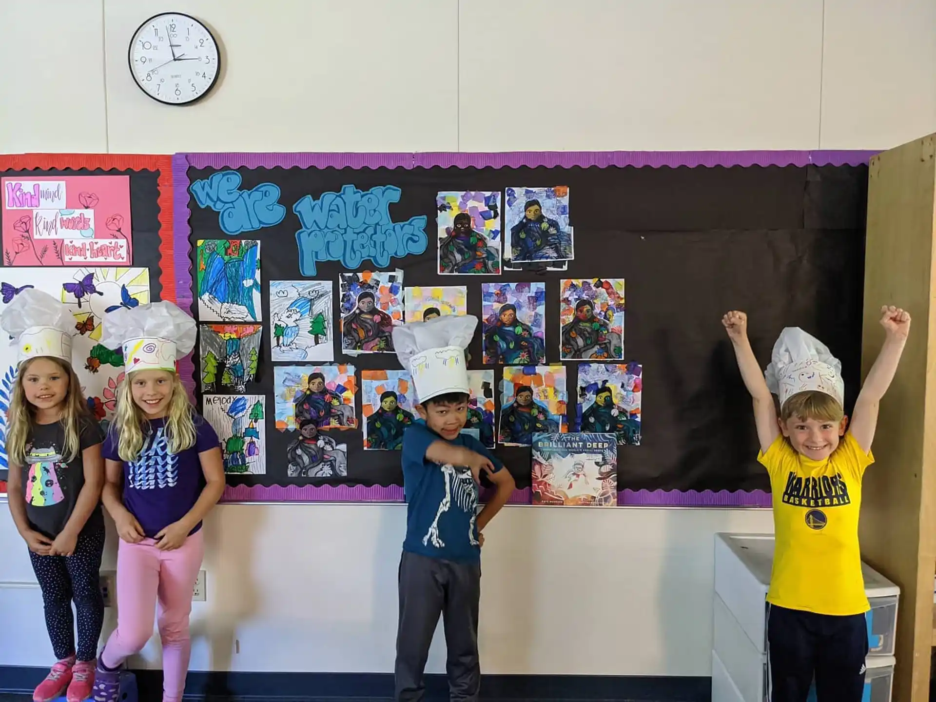 a group of children wearing paper hats