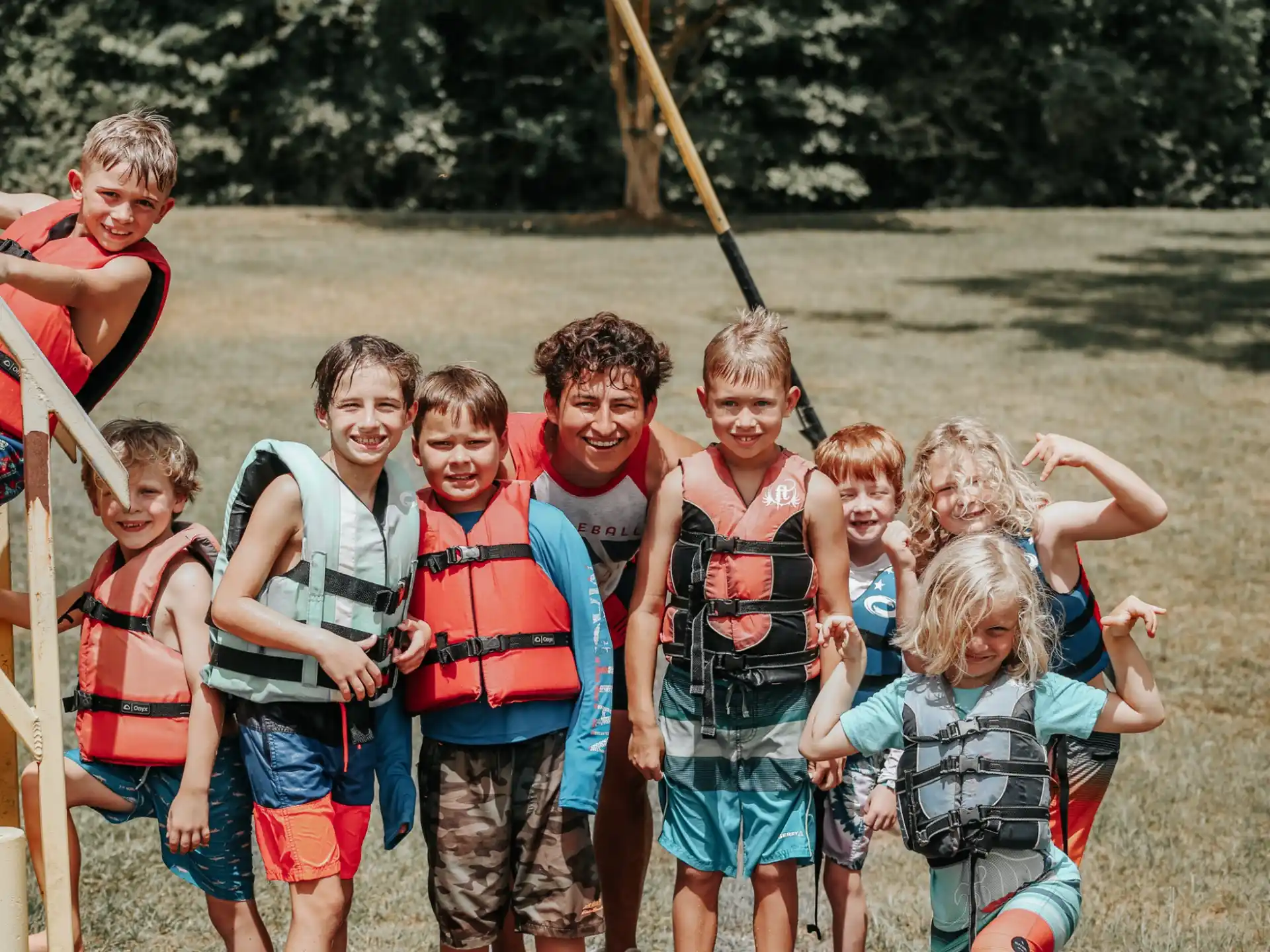 a group of children wearing life vests