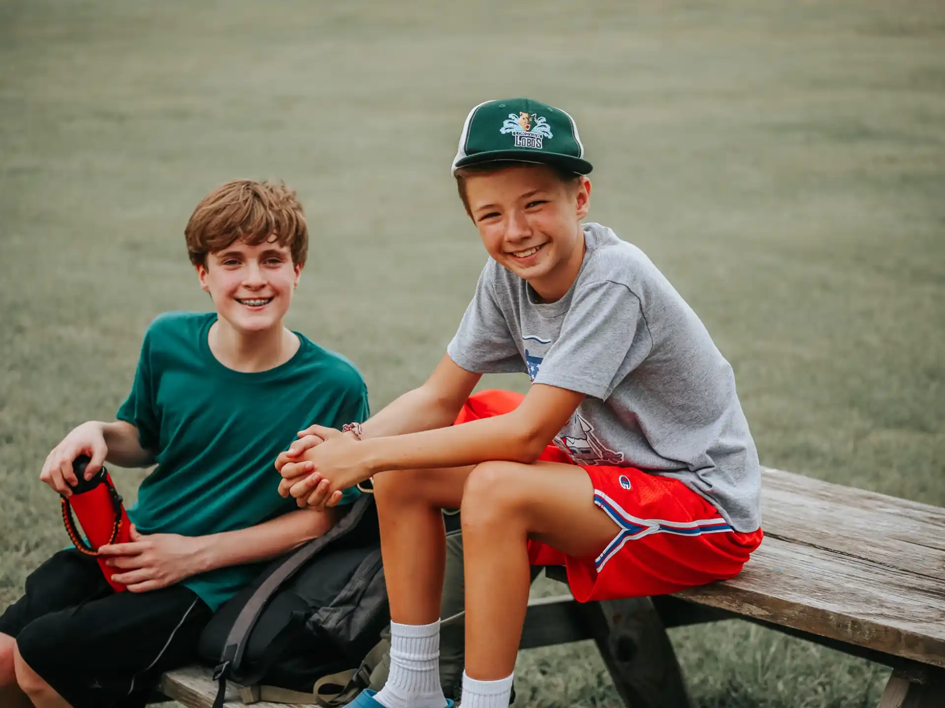 a person and a boy sitting on a bench