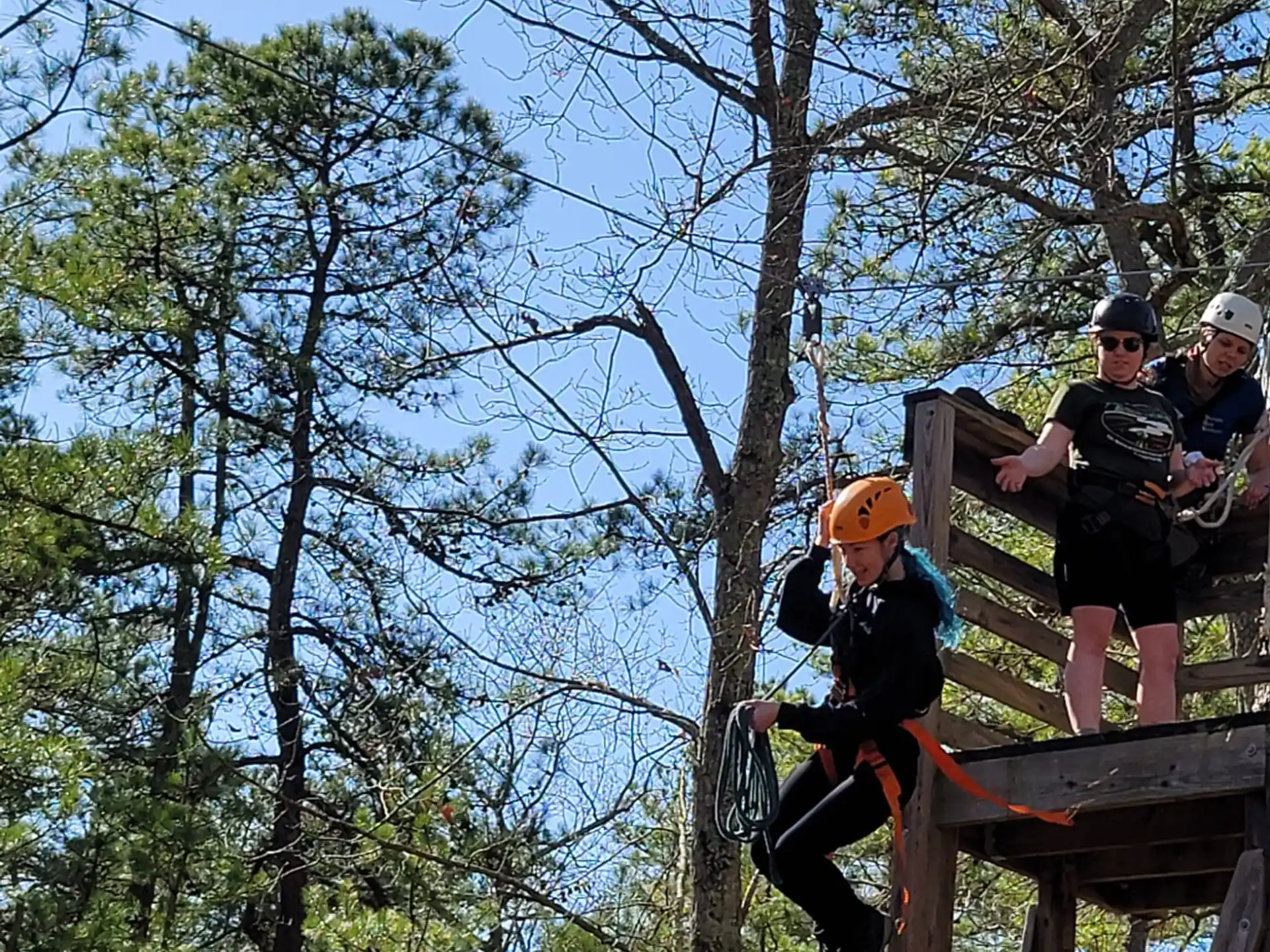 a group of people on a wooden bridge