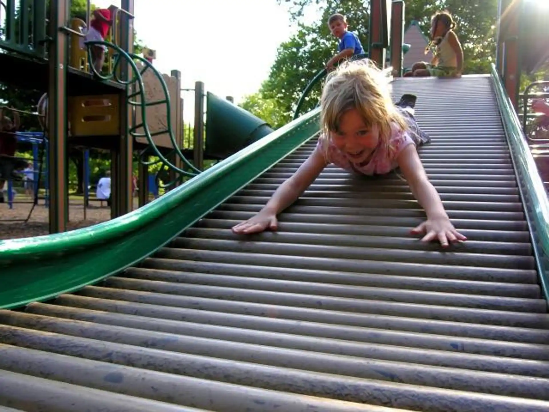 a girl sliding down a slide