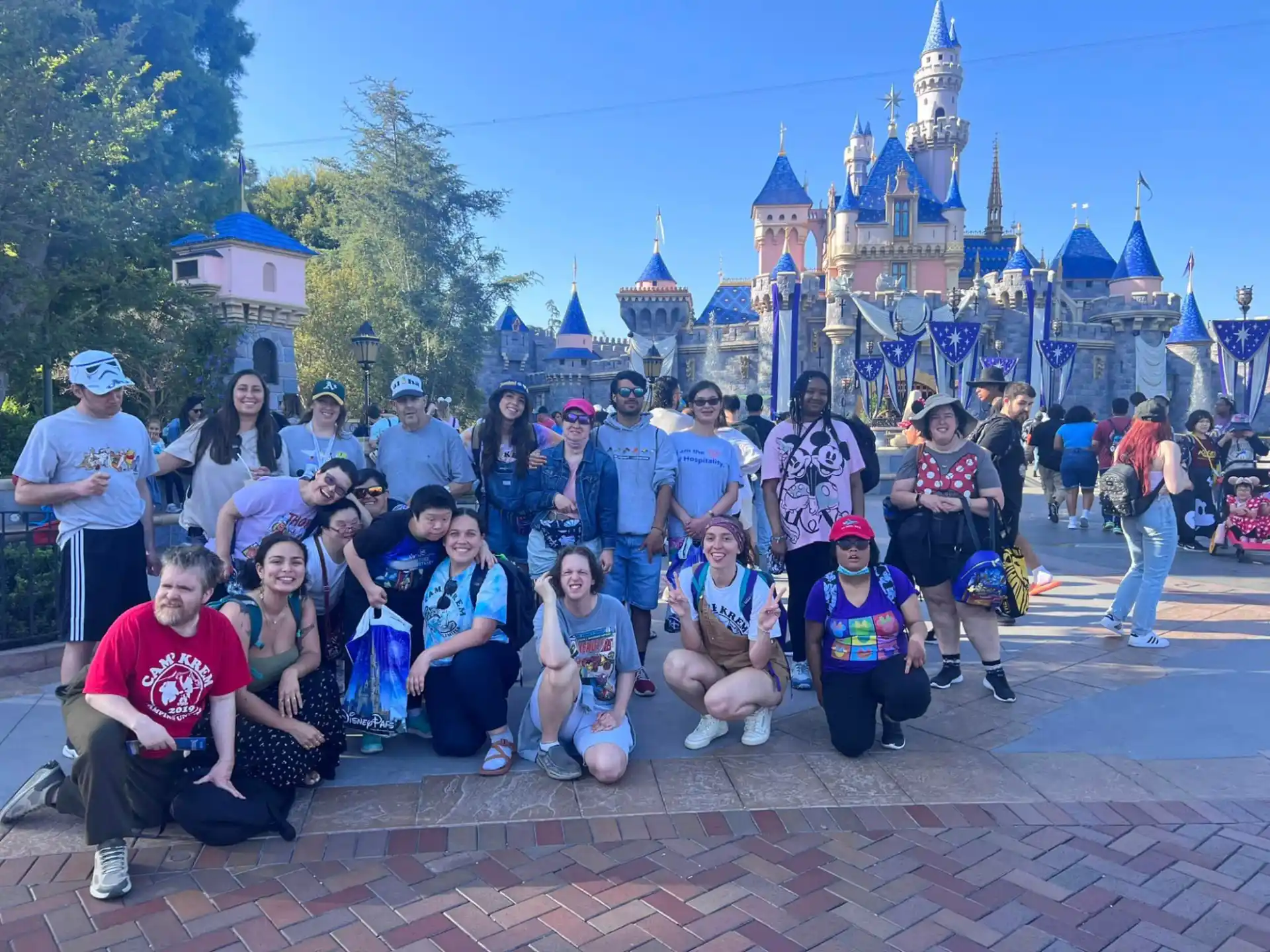 a group of people posing for a photo in front of a castle