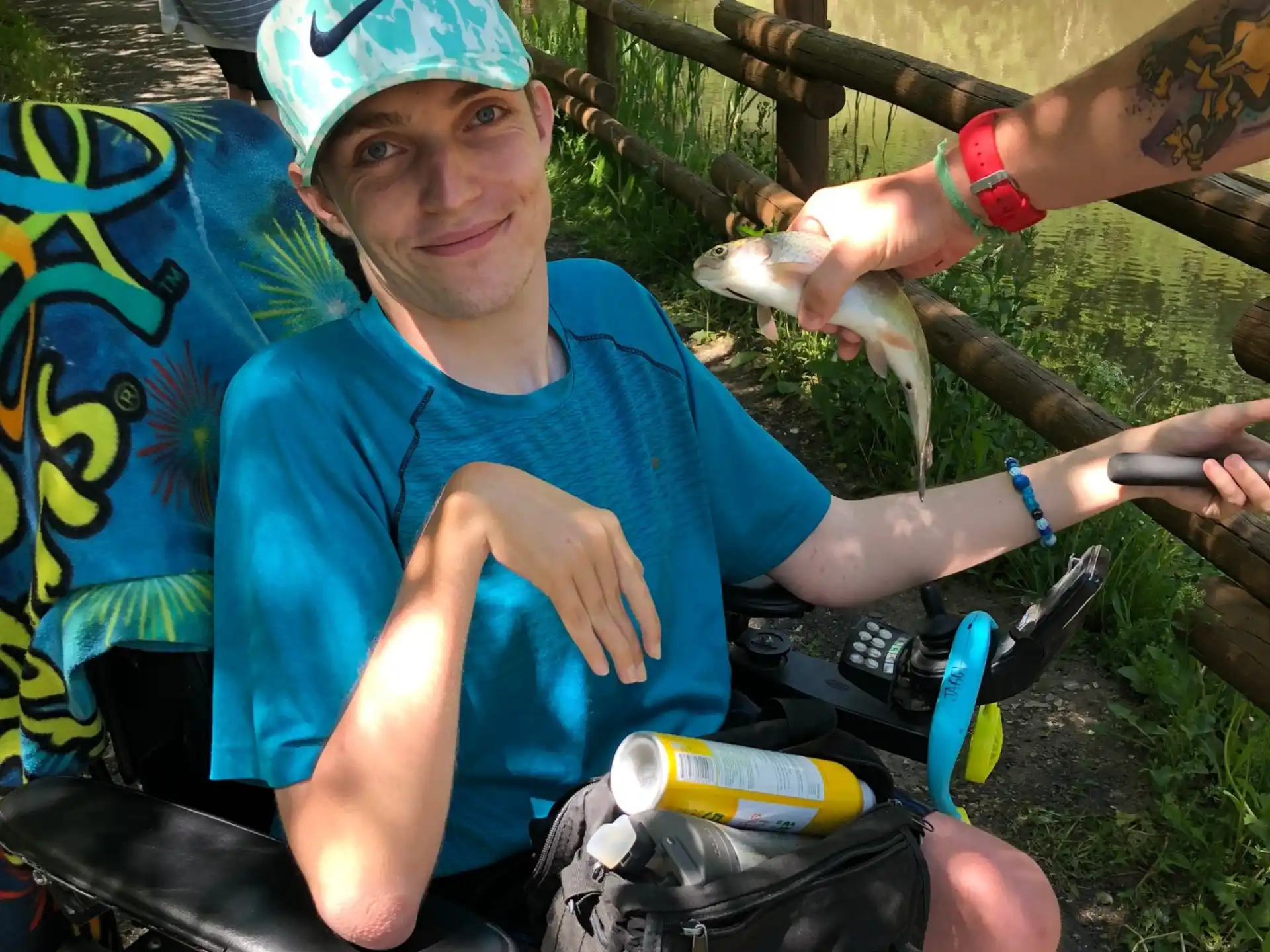 a person sitting in a chair holding a fish
