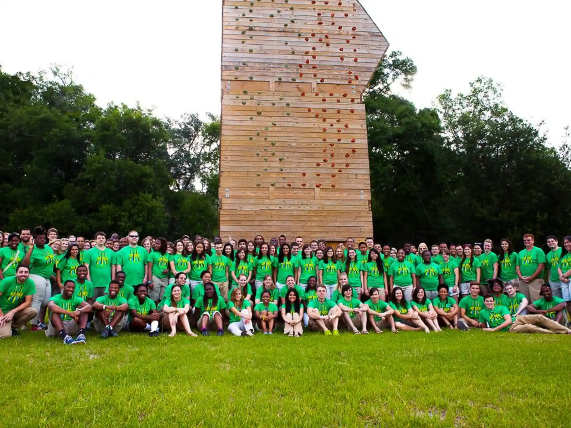 a group of people posing for a photo in front of a monument