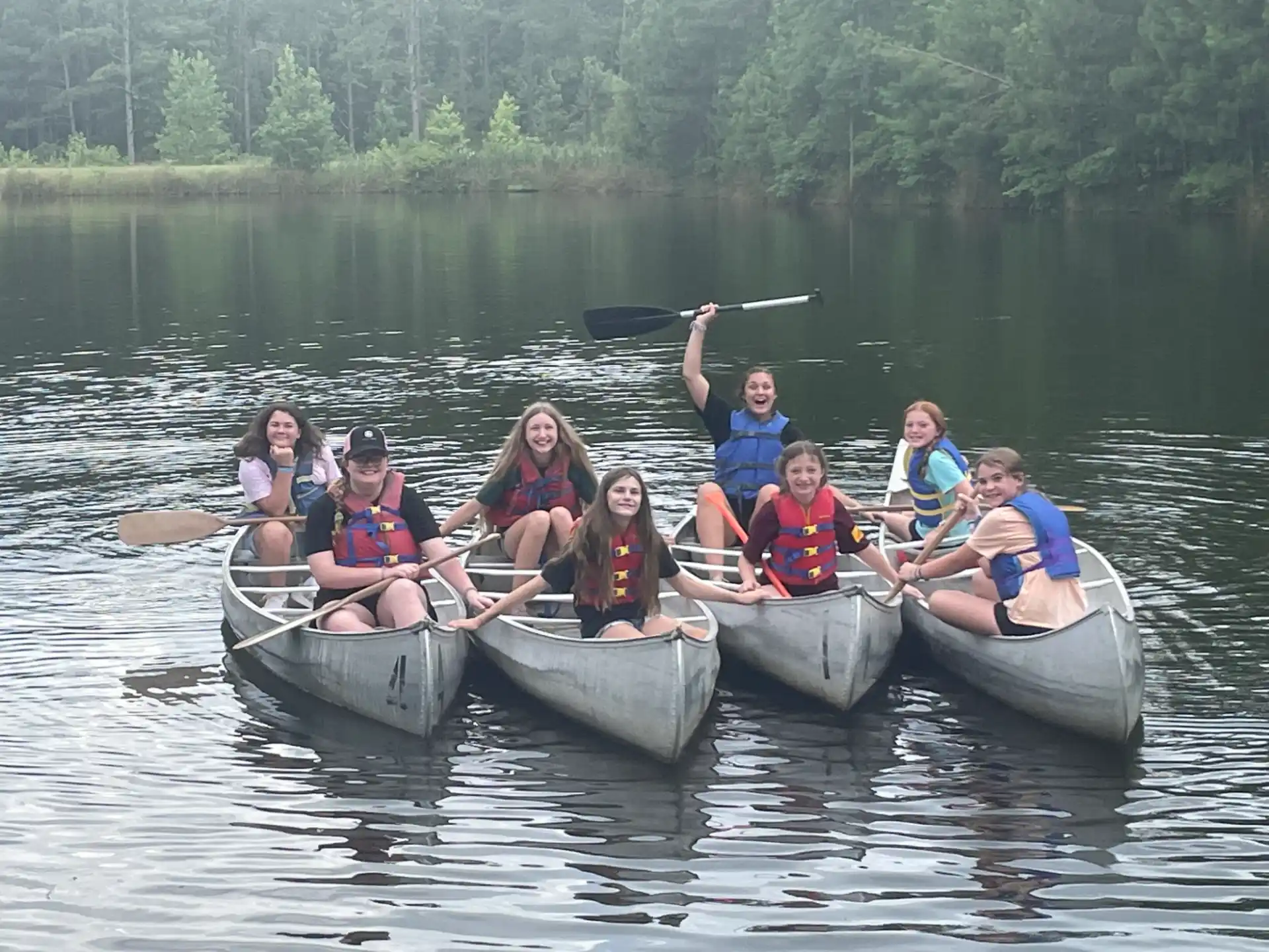 a group of people rowing a boat