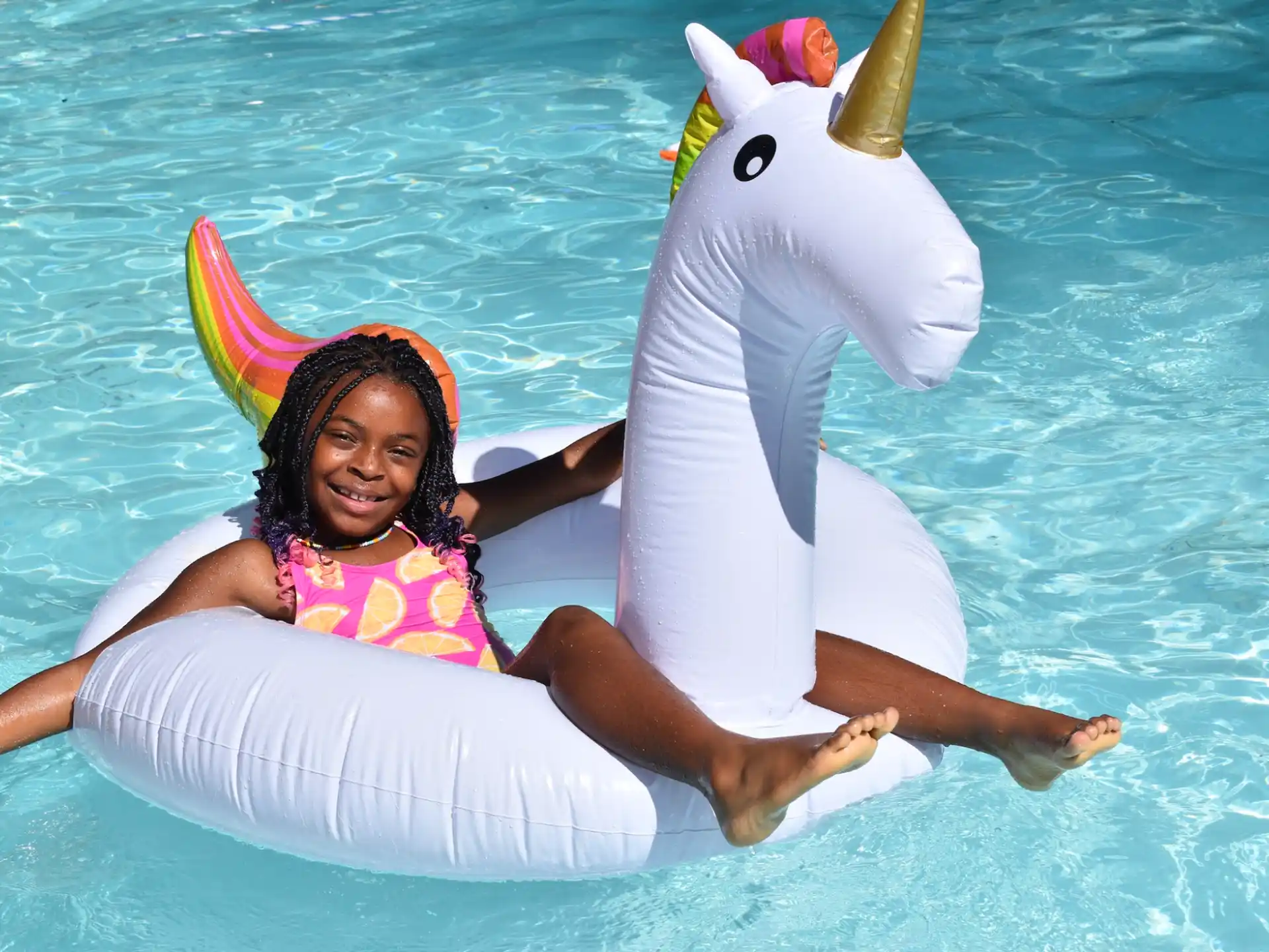 a girl in a horse mask and a dolphin in the water
