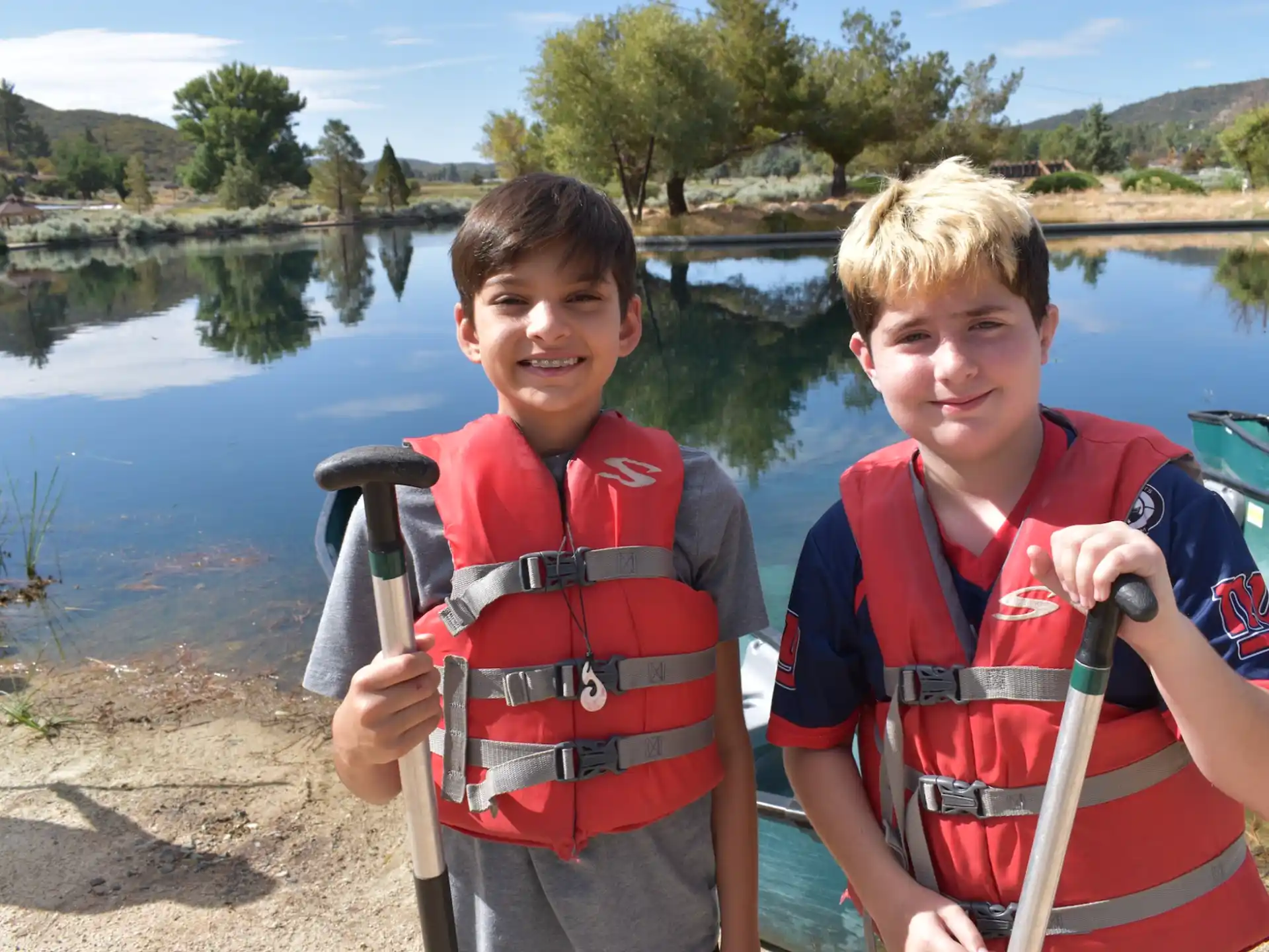two boys wearing life jackets