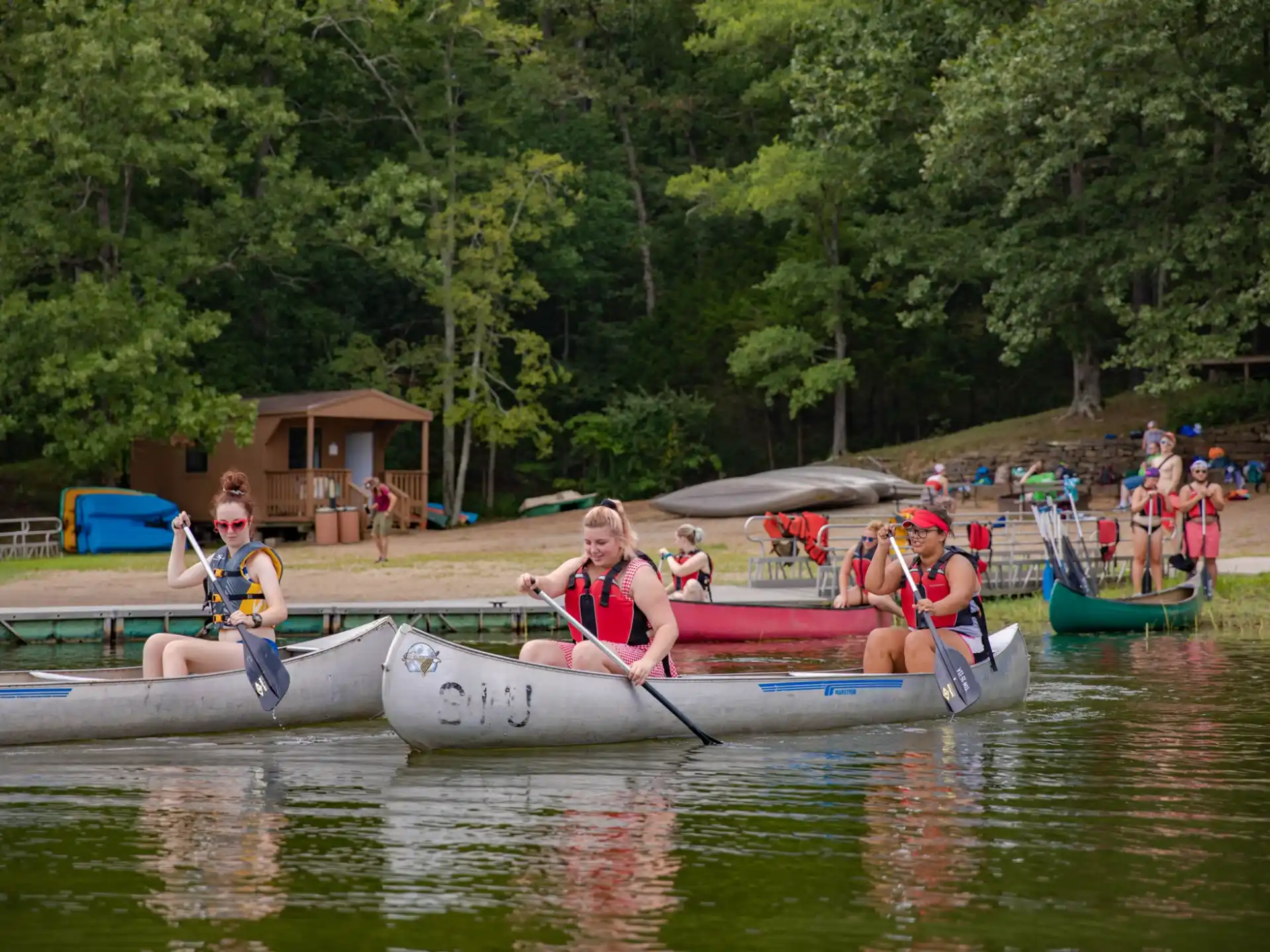 a group of people rowing boats