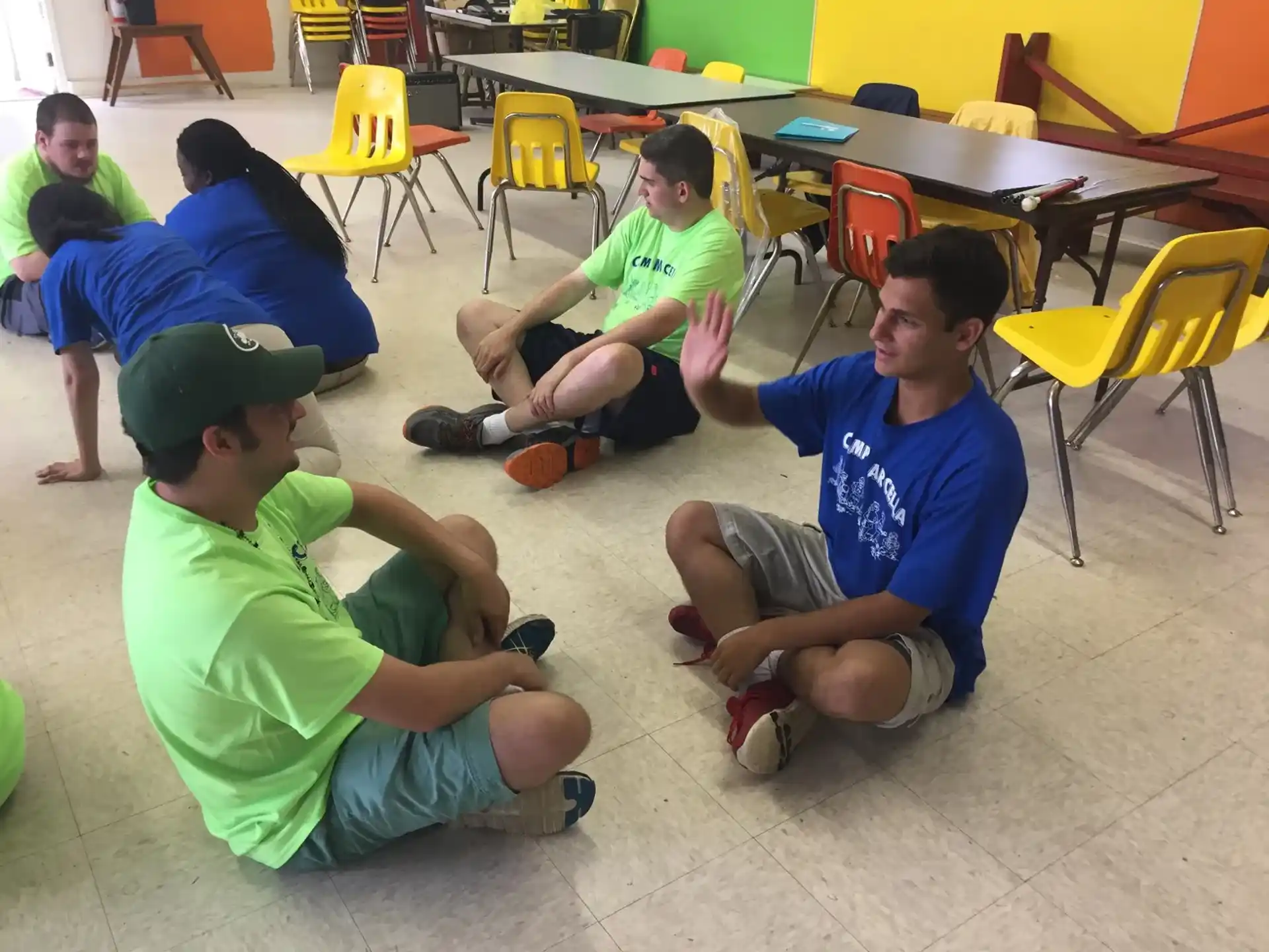 a group of boys sitting on the floor