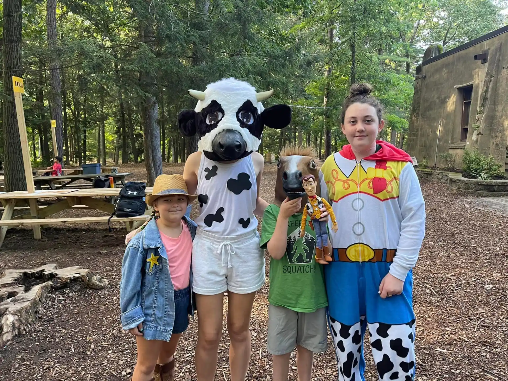 a group of people posing with a person in a panda garment