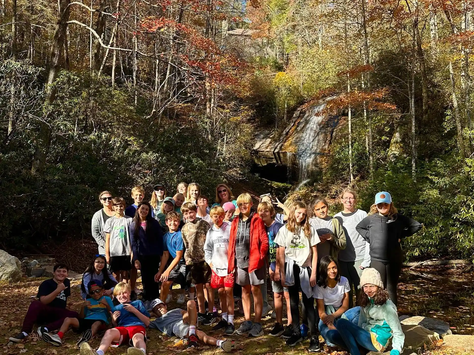 a group of people posing for a photo in the woods