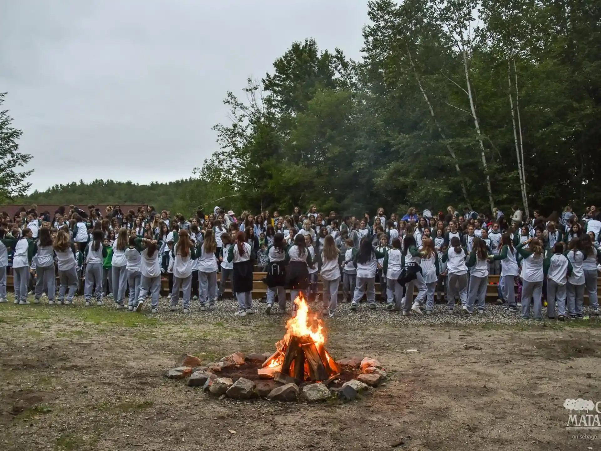 a group of people standing around a fire