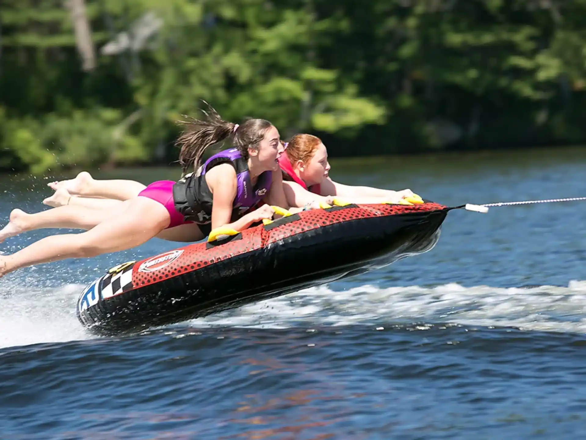 a couple of girls on a raft