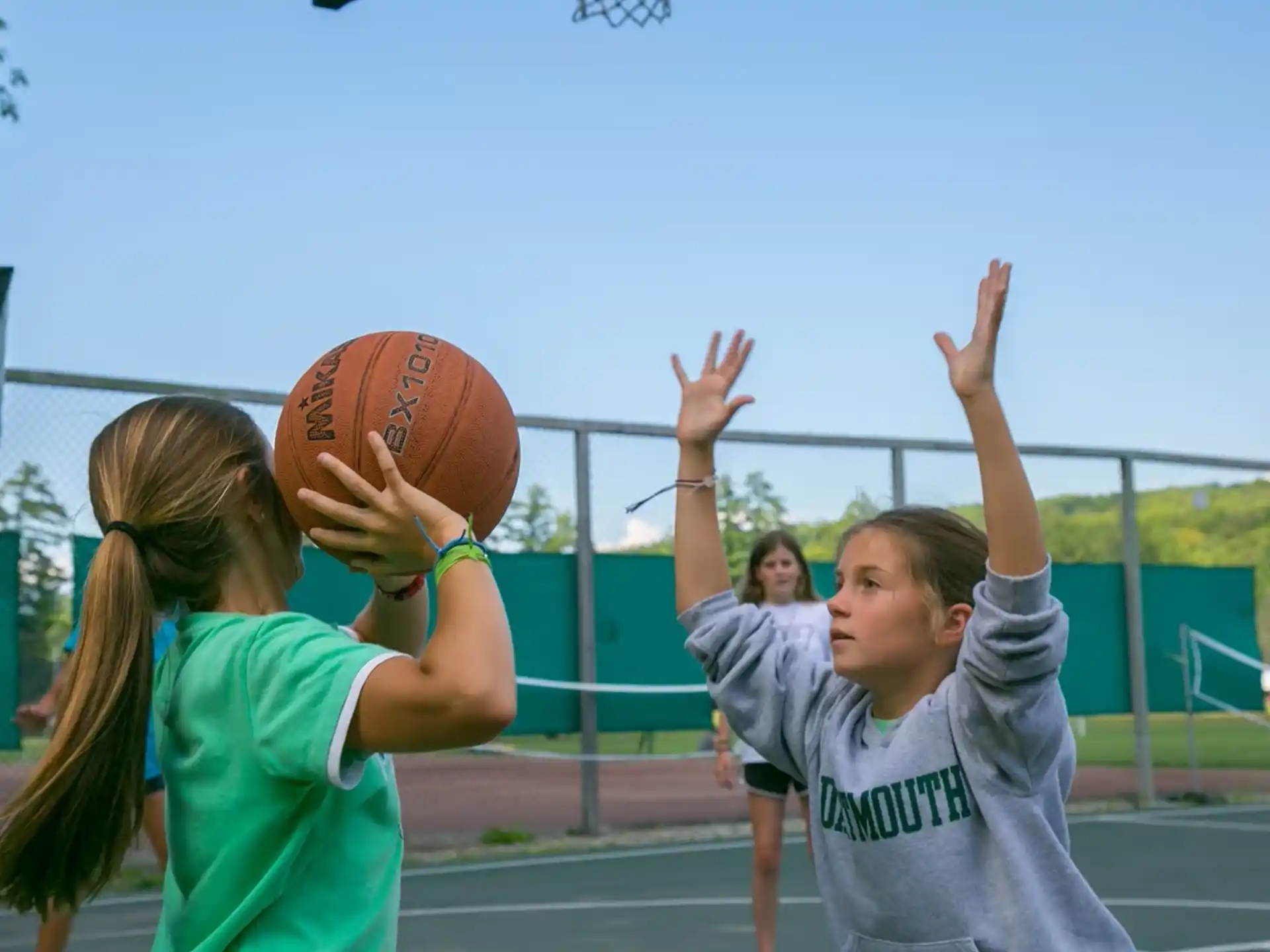 a couple of girls playing basketball