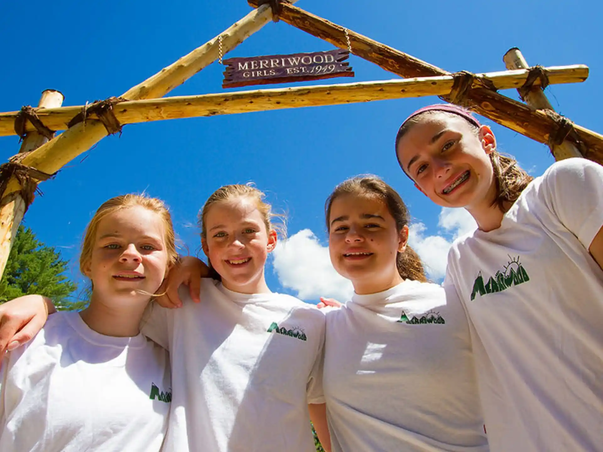 a group of girls wearing white shirts