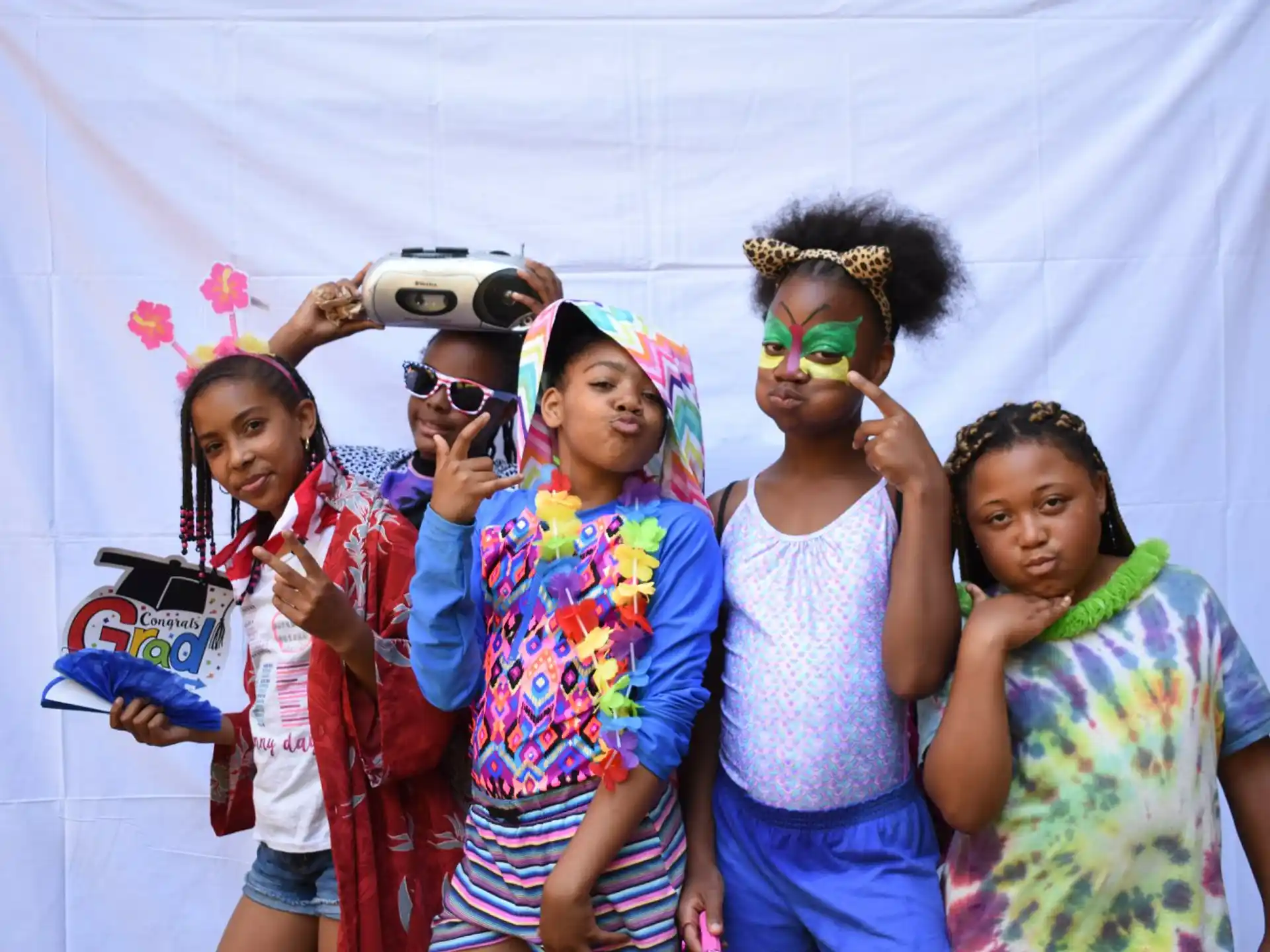 a group of people holding objects posing for the camera