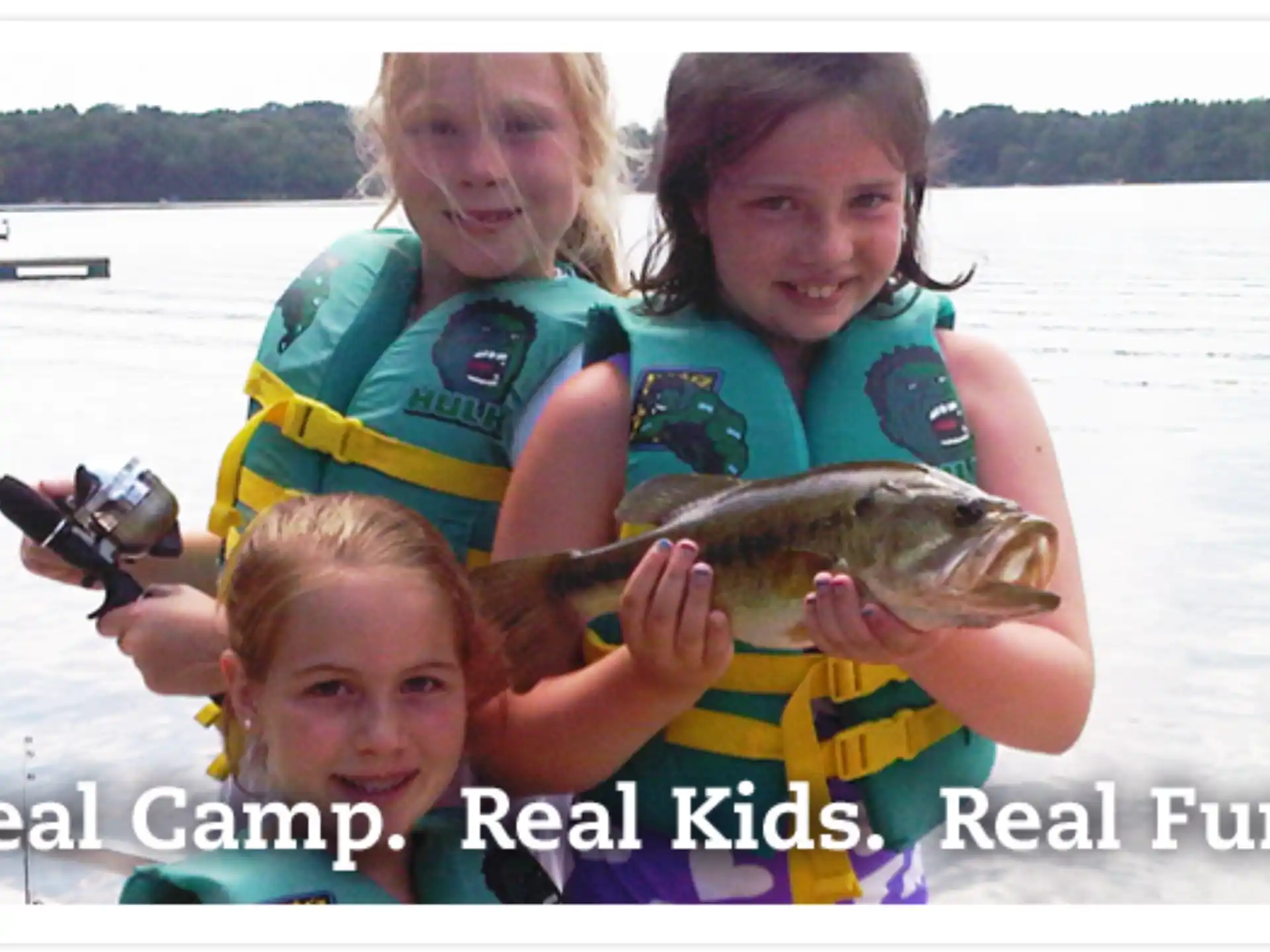 a group of kids holding a fish