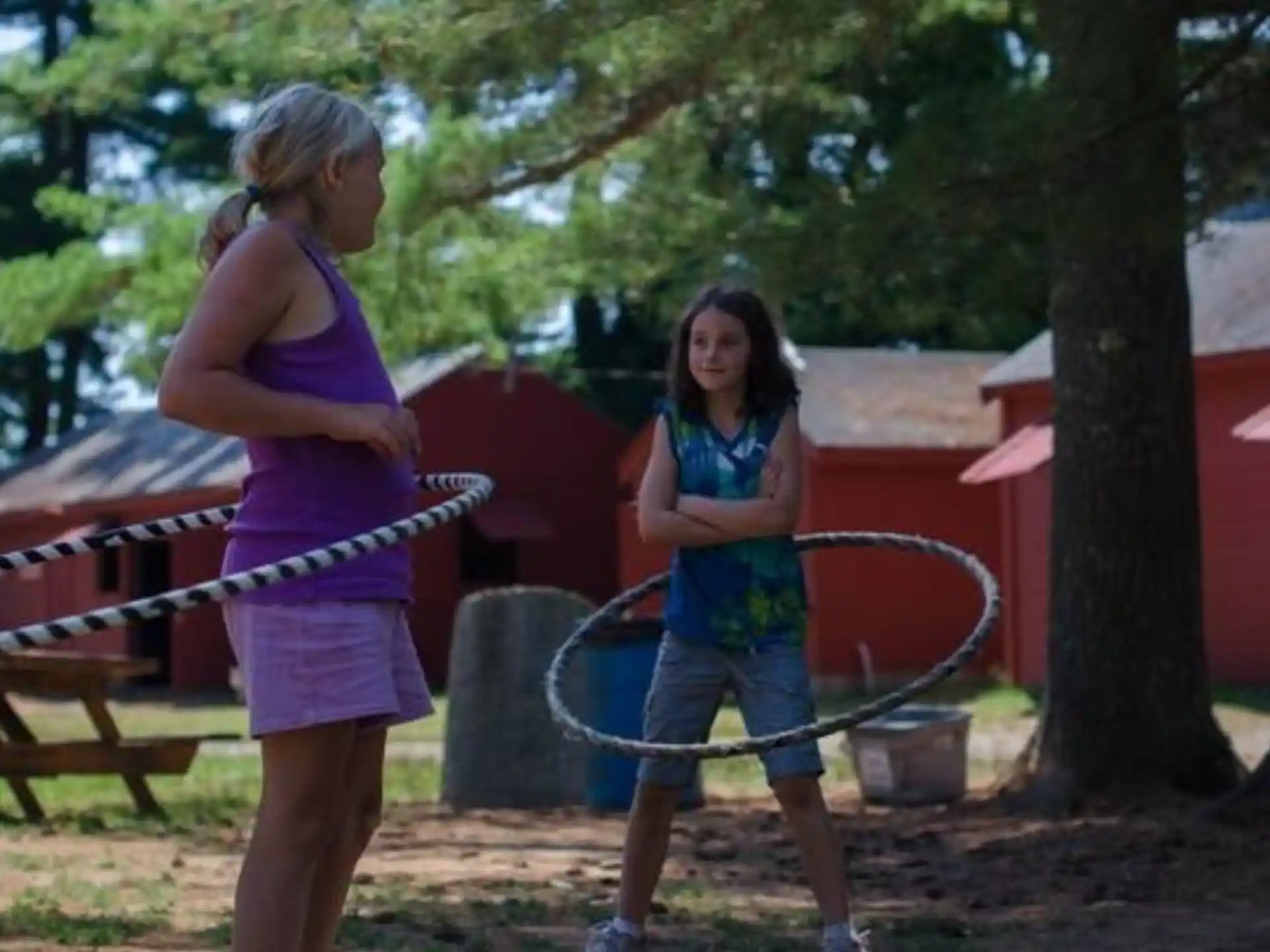 a couple of girls playing with a toy sword