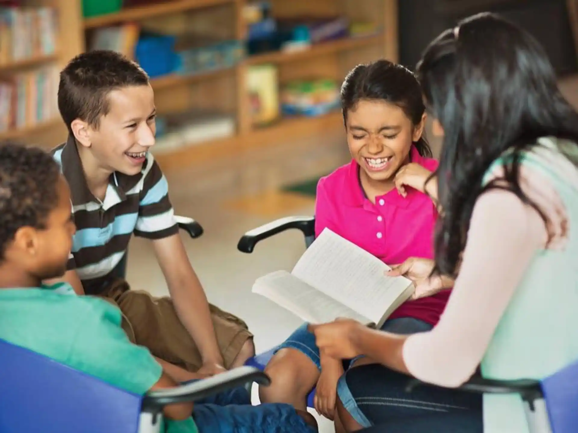 a teacher reading a book to her students