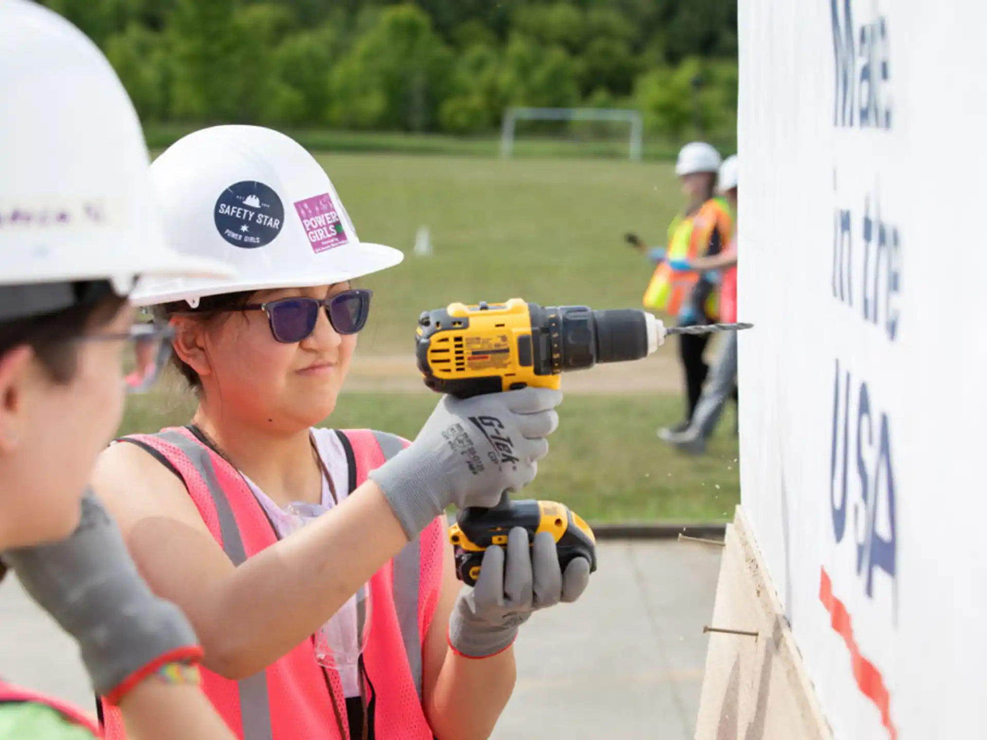 a person wearing a helmet and holding a drill