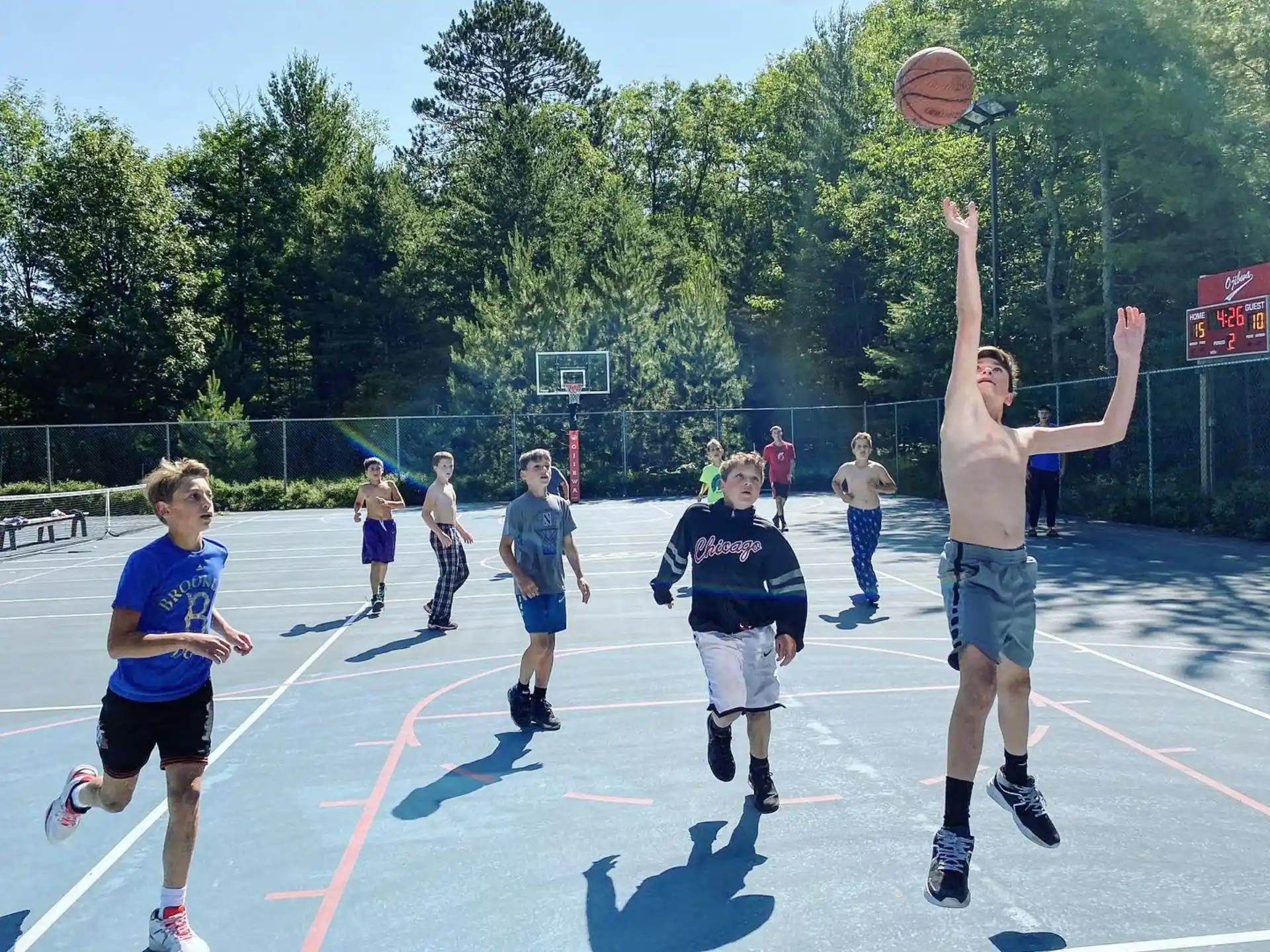 a group of people playing basketball