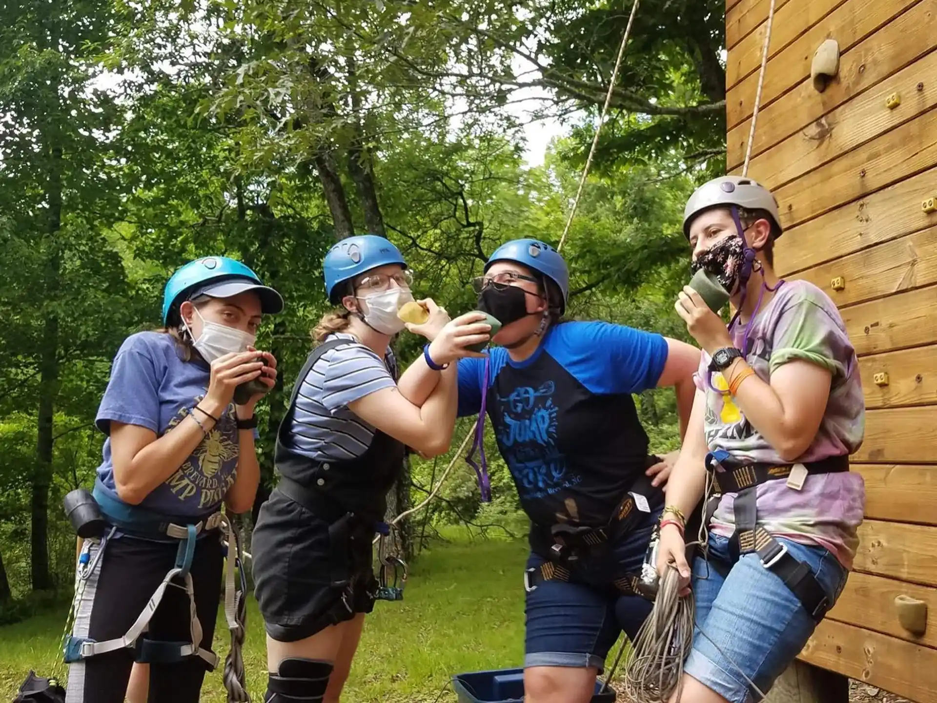 a group of people wearing helmets and harnesses