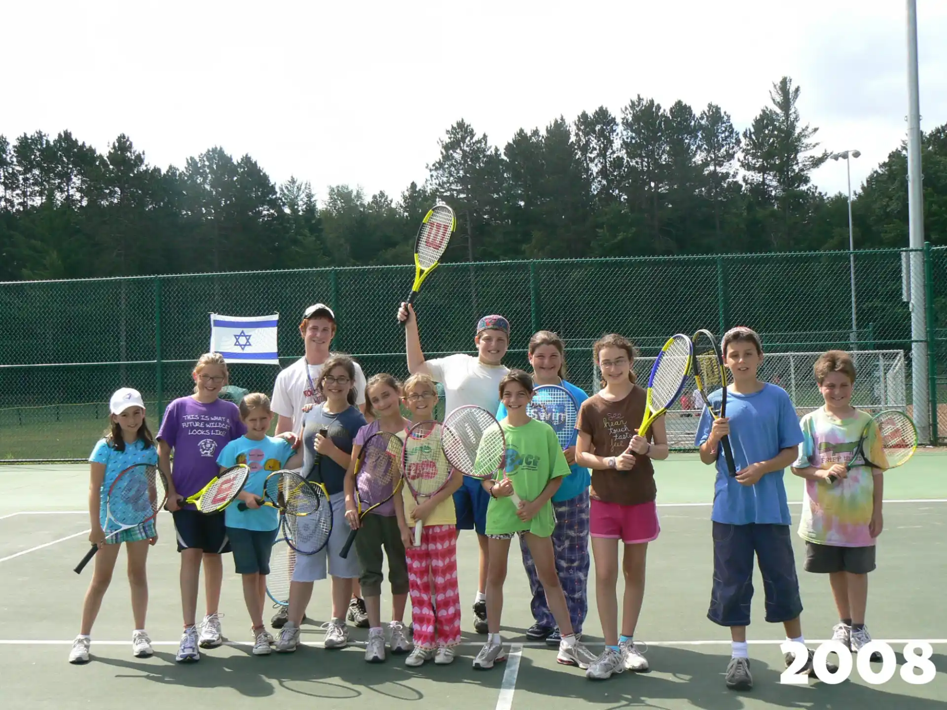 a group of kids holding tennis rackets