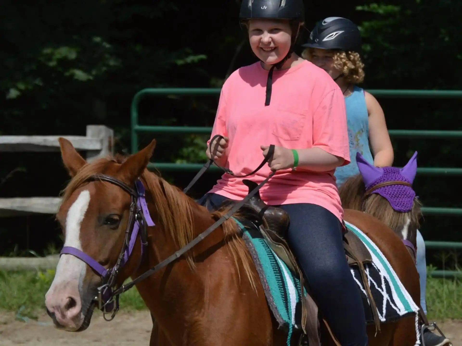 a person riding a horse with a couple of girls on it