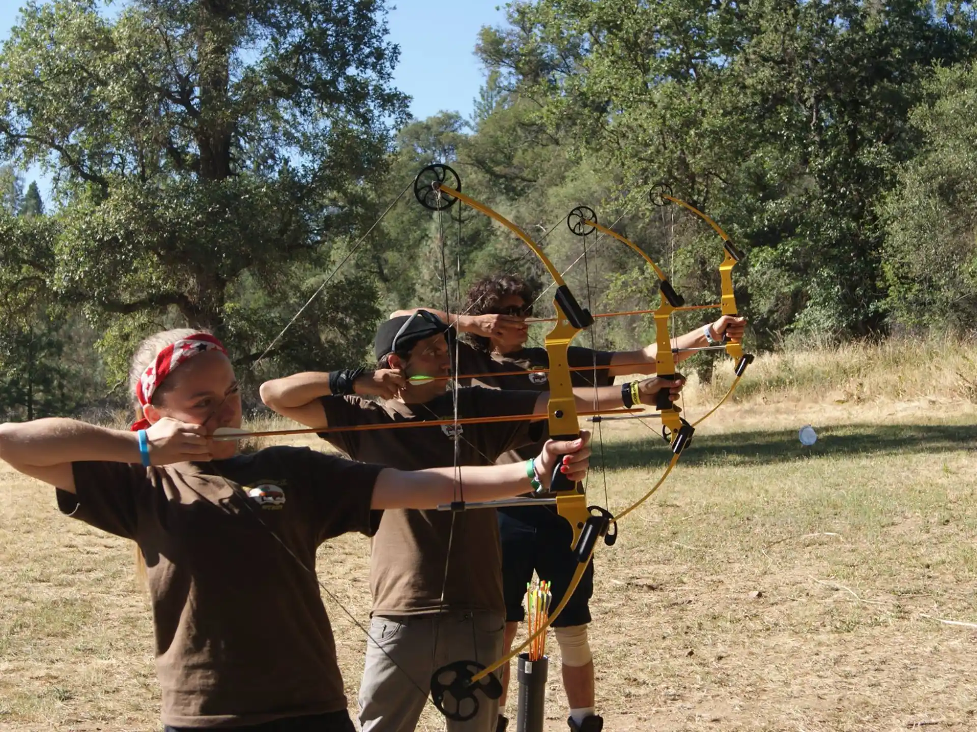 a group of people shooting bows