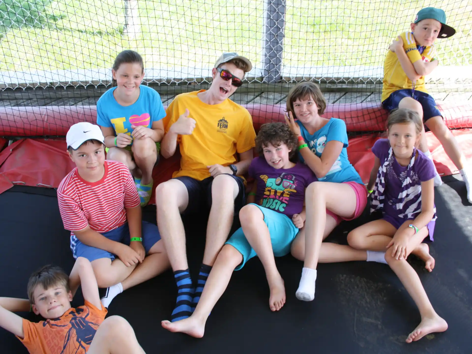 a group of people sitting on a trampoline