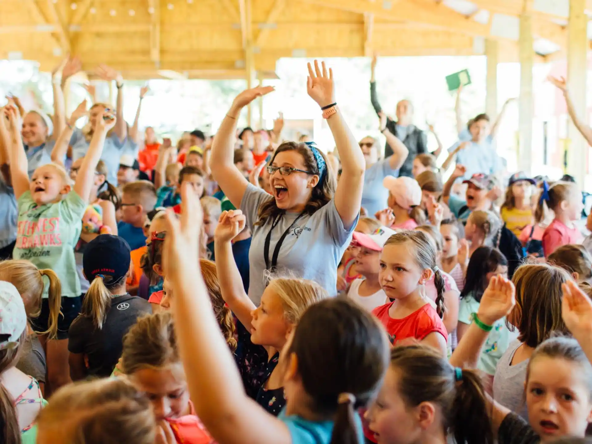 a person with the hands up in the air in front of a crowd