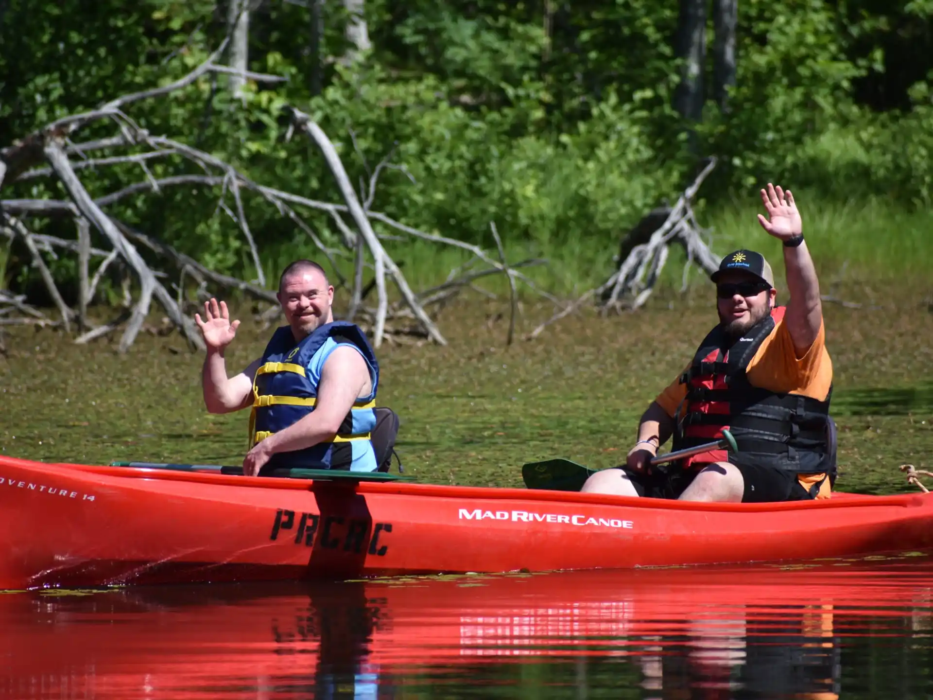 a couple of men in a canoe
