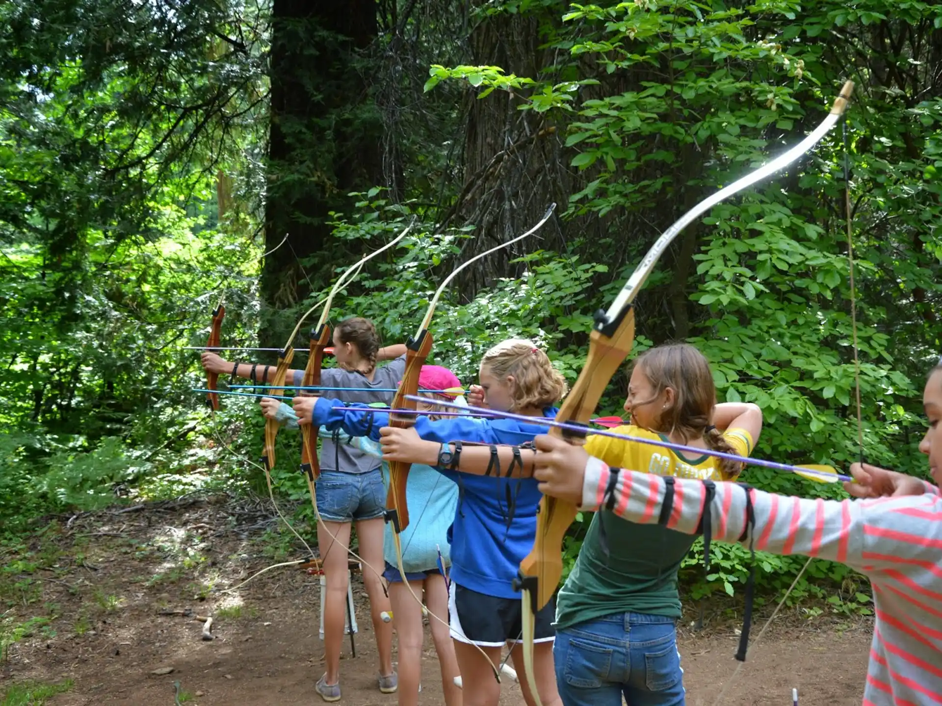 a group of people holding bows and arrows